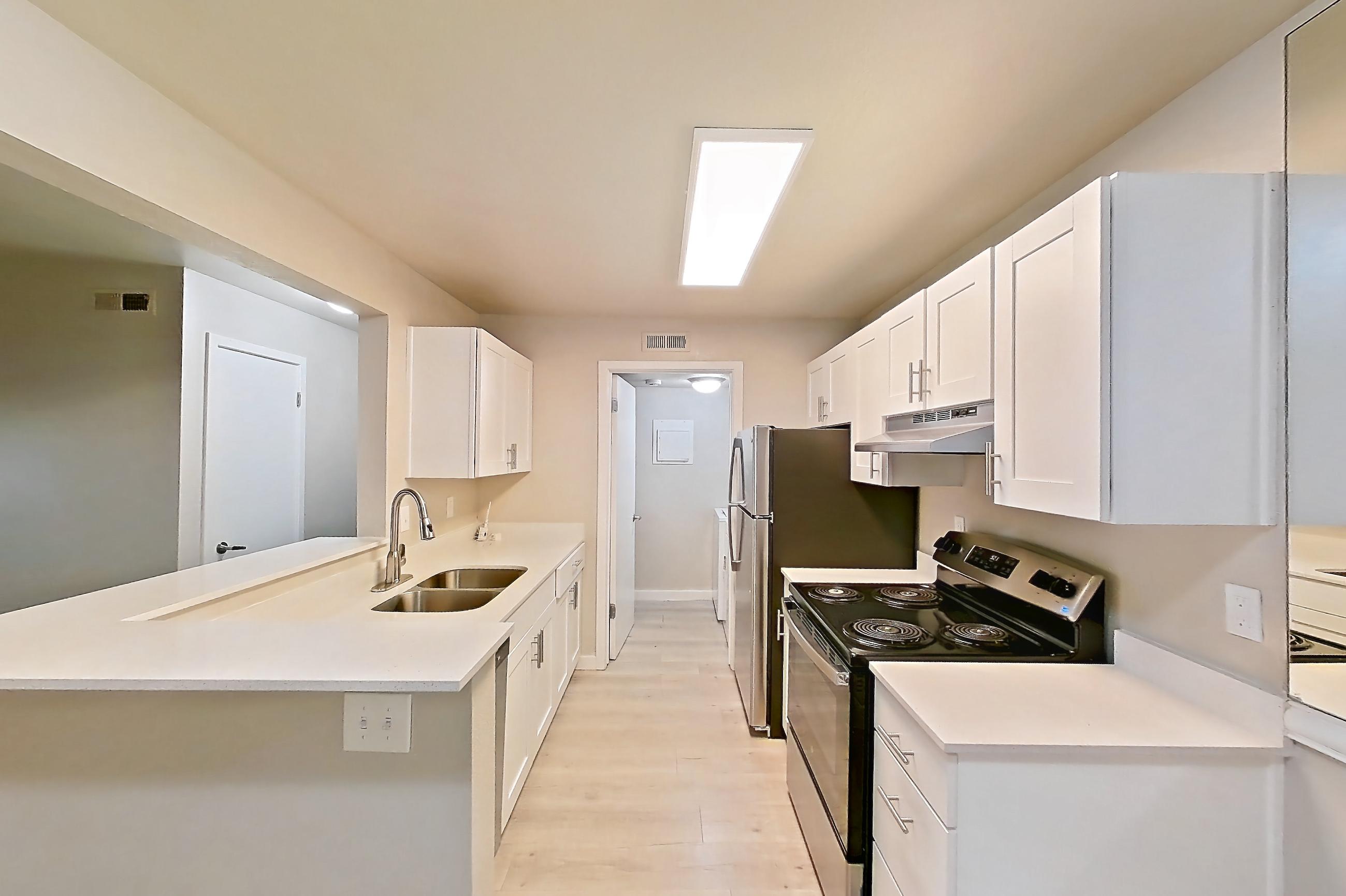 Dining room with dishwasher, electric range, light stone countertops, light wood-finish flooring, oven/range, refrigerator, and stainless steel appliances, Apartment 02H at James Pointe