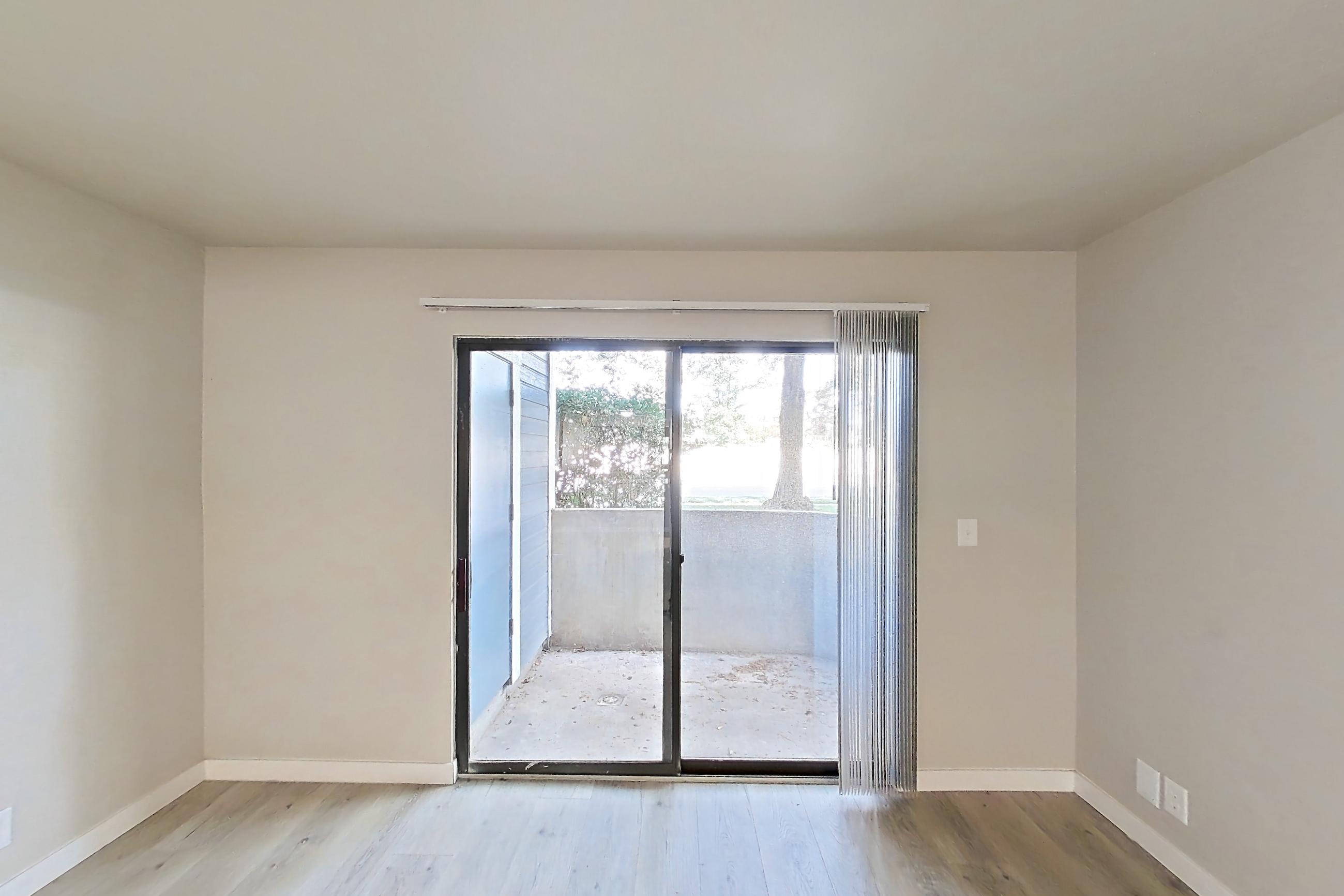 Living room with light wood-finish flooring, Apartment 02H at James Pointe
