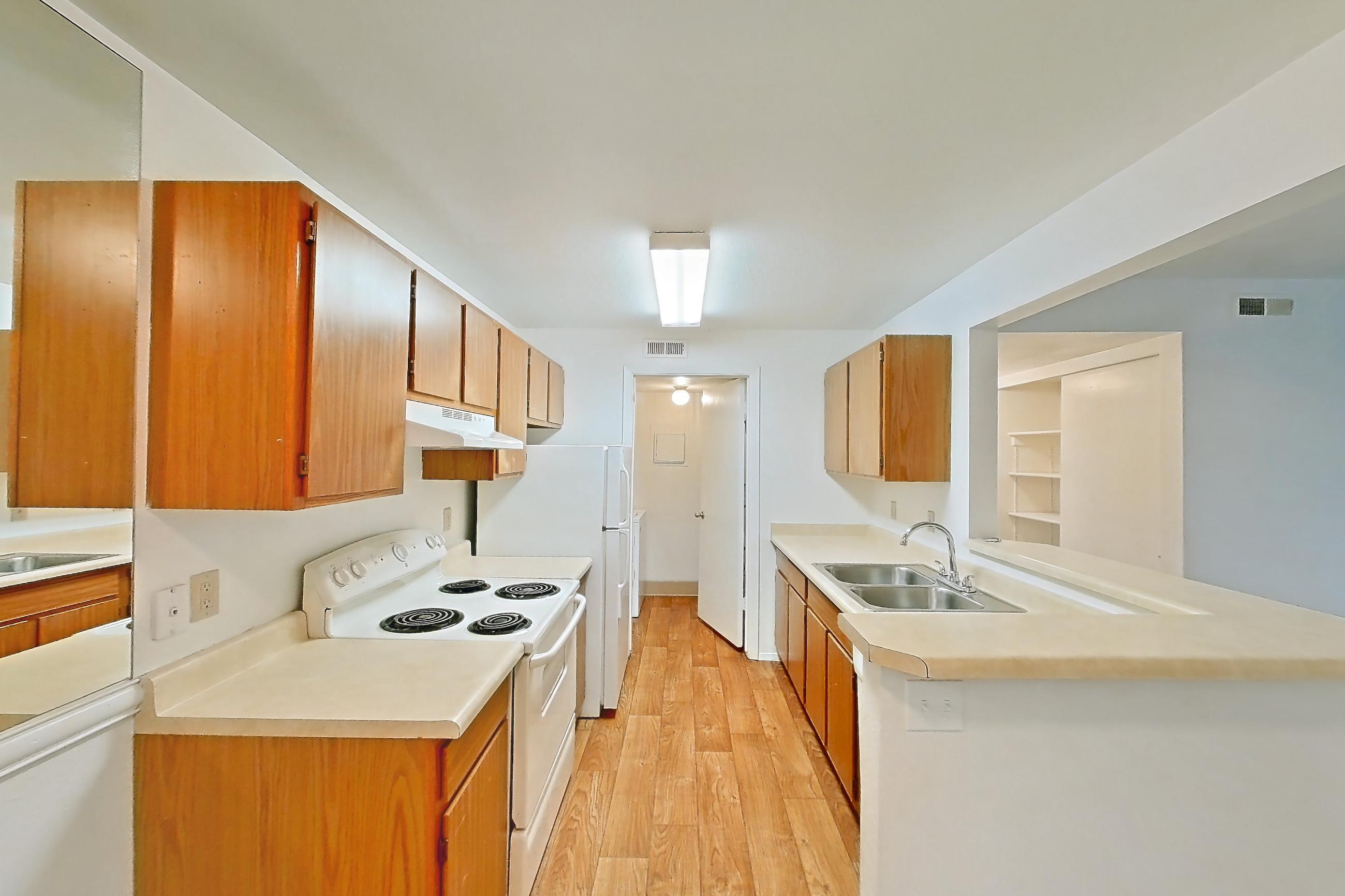 Dining room with dishwasher, electric range, light carpet, light countertops, oven/range, refrigerator, and white appliances, Apartment 12U at James Pointe