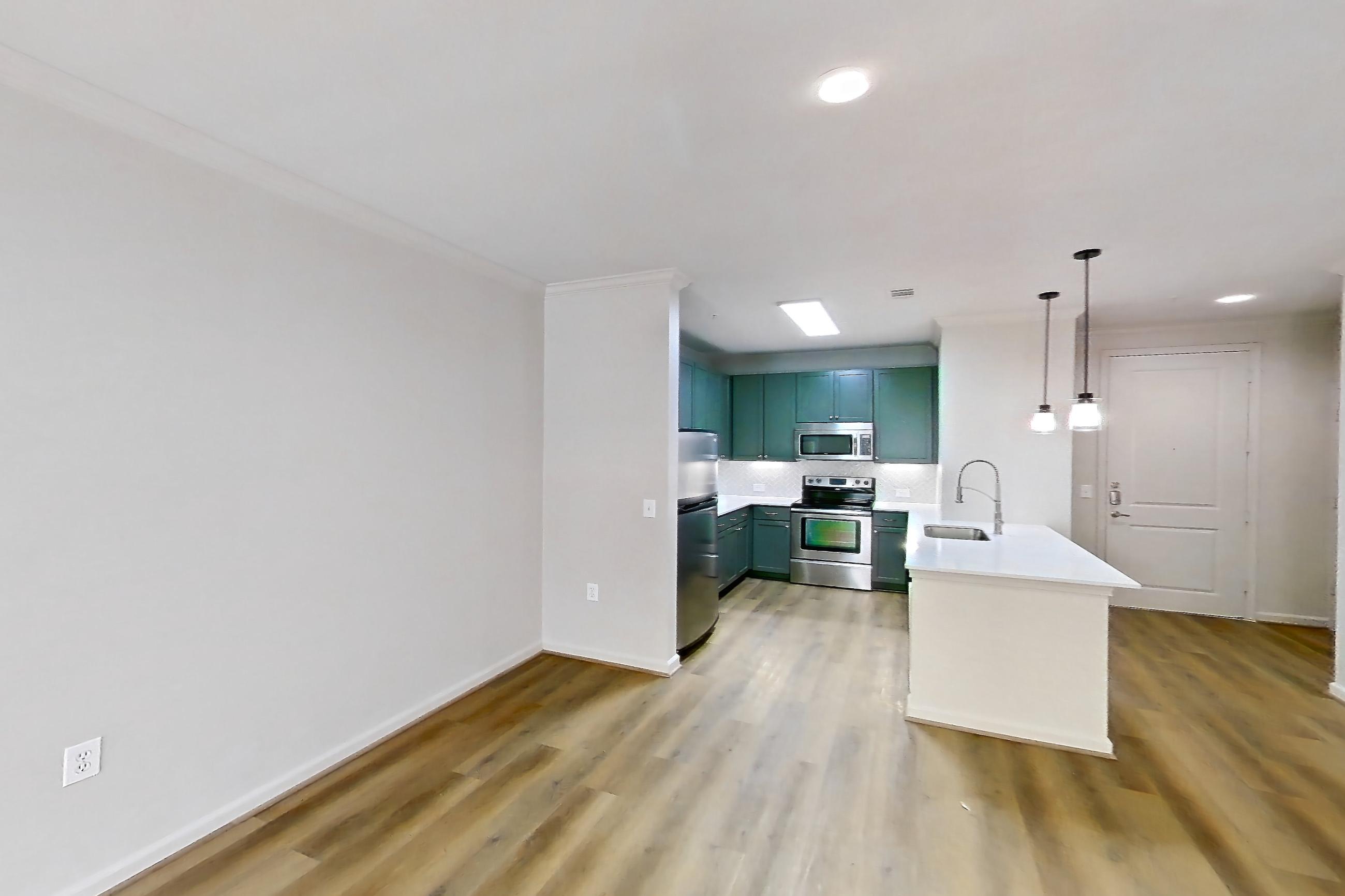 Living room with electric range, light stone countertops, light wood-finish flooring, oven/range, refrigerator, and stainless steel appliances, Apartment 2052 at La Maison at River Oaks