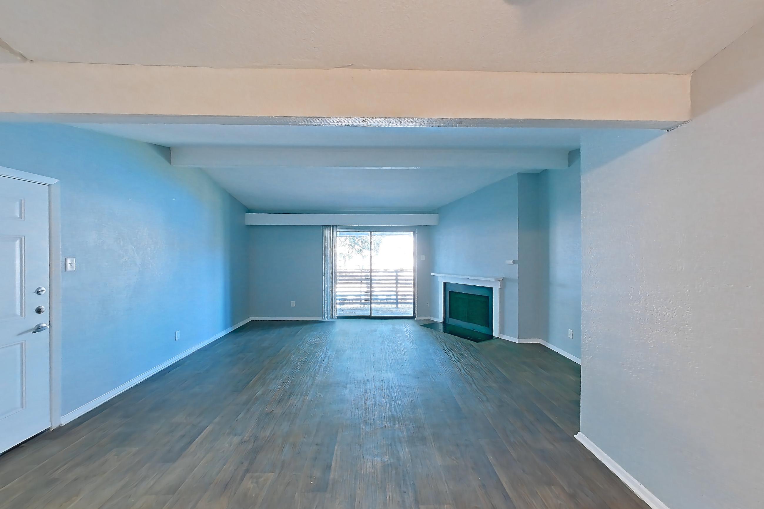 Dining room with black appliances, dark wood-finish flooring, electric range, fireplace, light countertops, oven/range, and refrigerator, Apartment 190 at Eleven600 Apartments