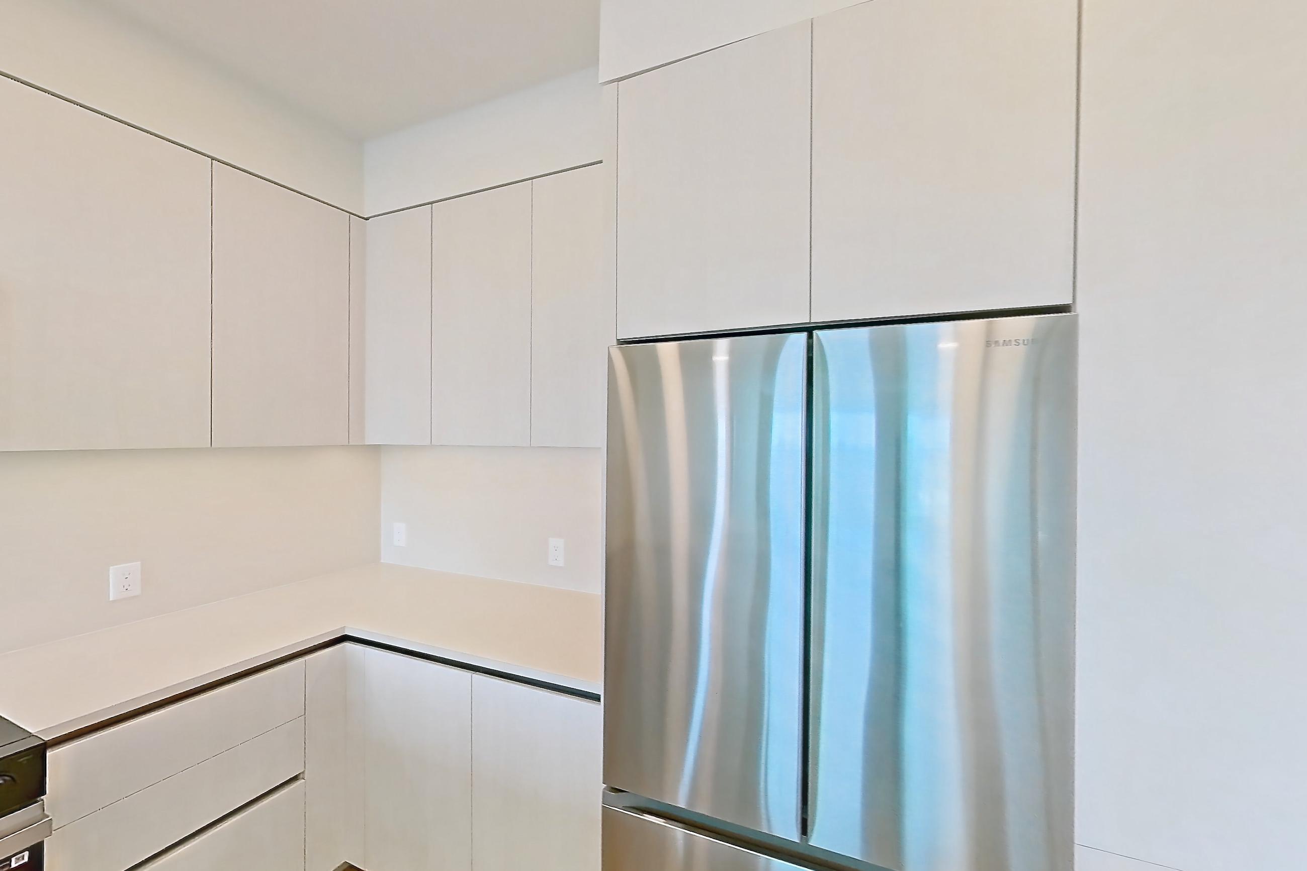 Kitchen with dishwasher, electric range, light countertops, light wood-finish flooring, microwave, oven/range, refrigerator, and stainless steel appliances, Apartment 739 at Rowyn