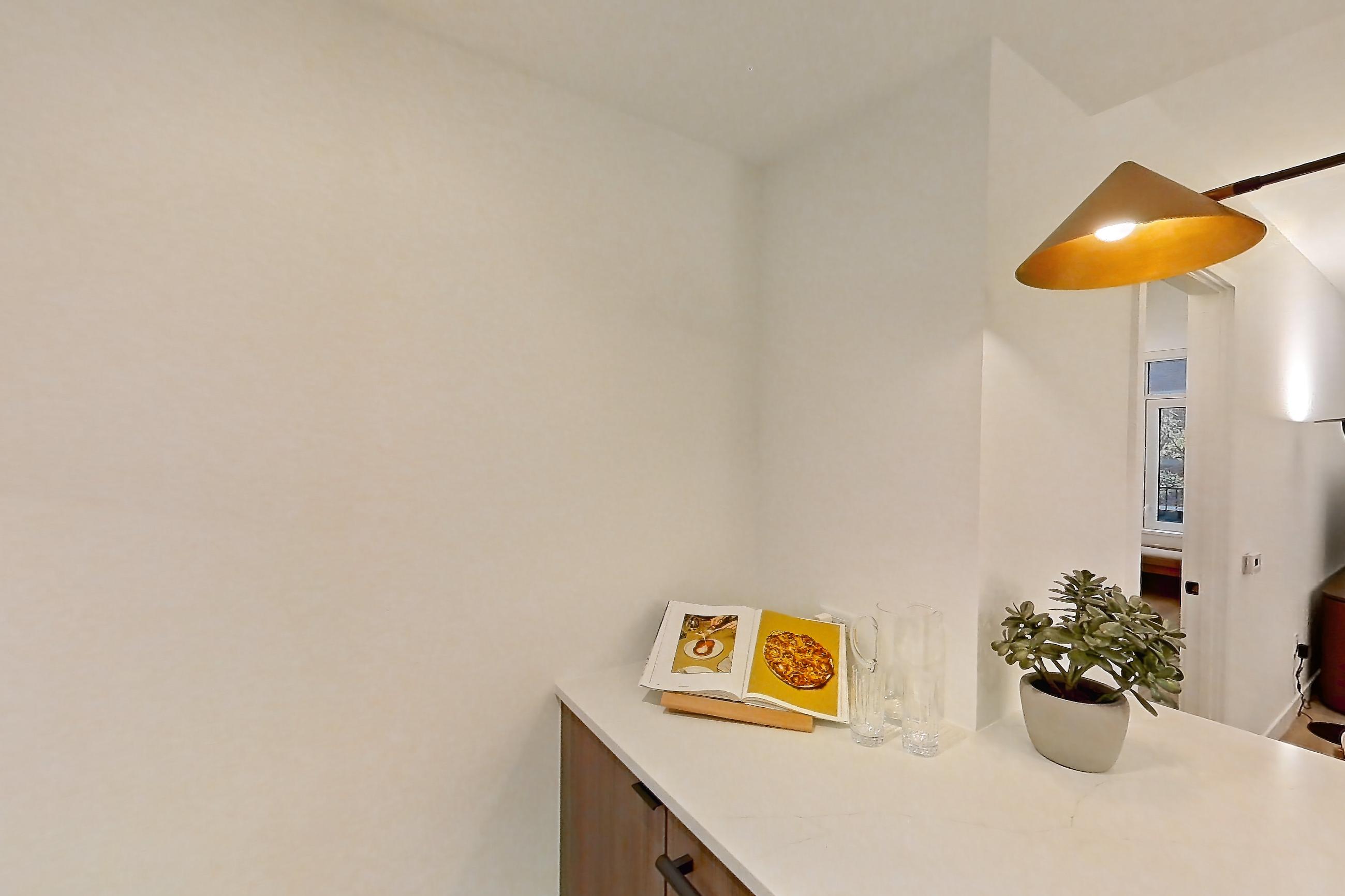 Kitchen with cooktop, gas cooktop, light stone countertops, light wood-finish flooring, oven/range, stainless steel appliances, white appliances, and wood-finish flooring, Apartment 03F at Maison 78