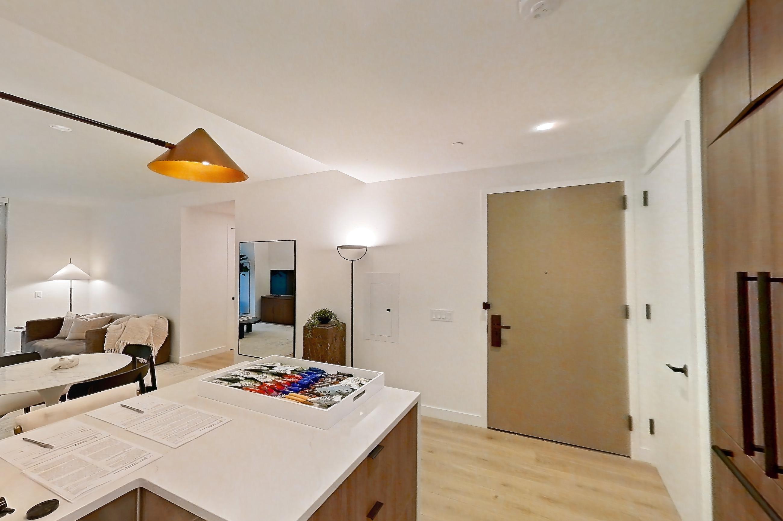 Kitchen with cooktop, gas cooktop, light stone countertops, light wood-finish flooring, oven/range, stainless steel appliances, white appliances, and wood-finish flooring, Apartment 03F at Maison 78