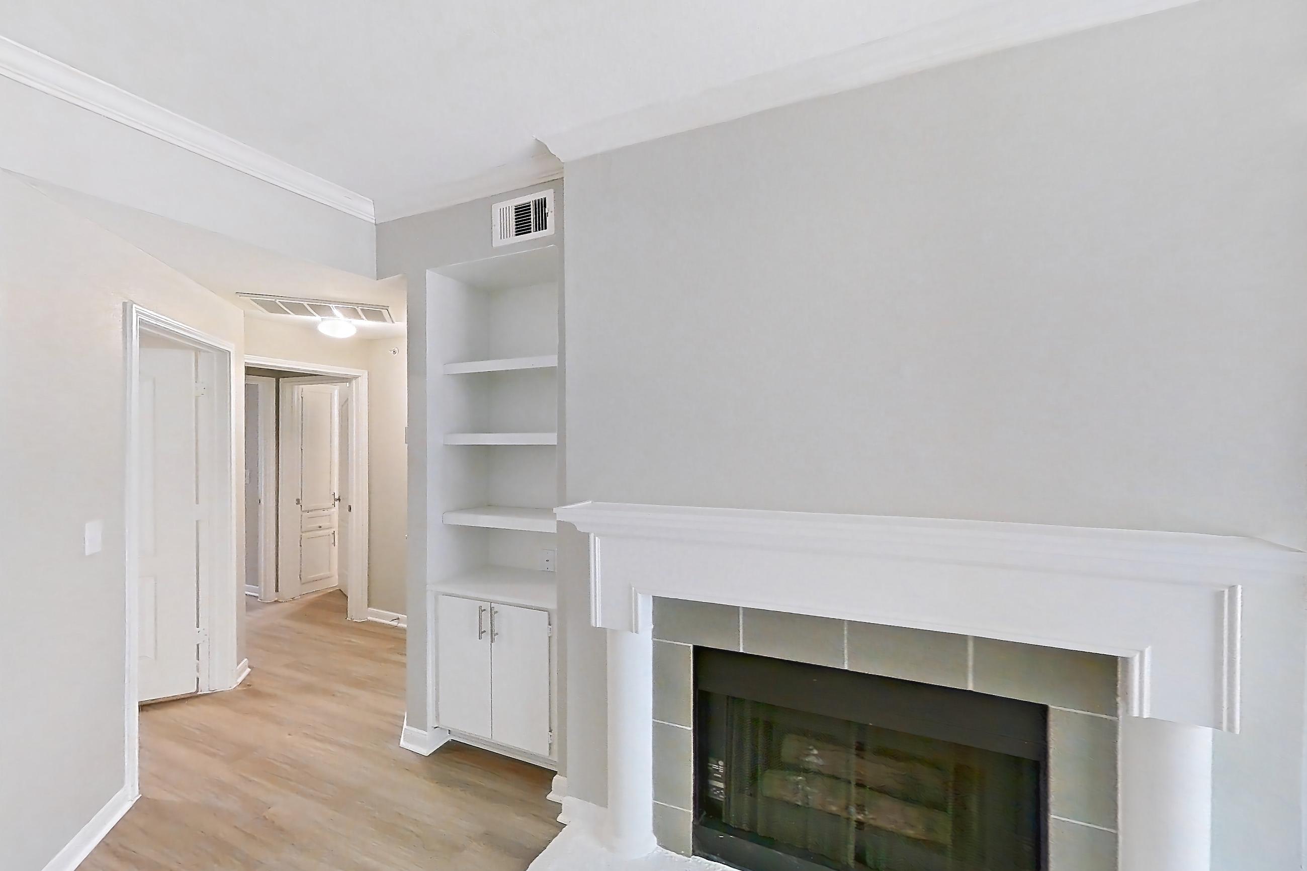 Living room with fireplace, light wood-finish flooring, and tile fireplace, Unit 307 at Riviera at West Village