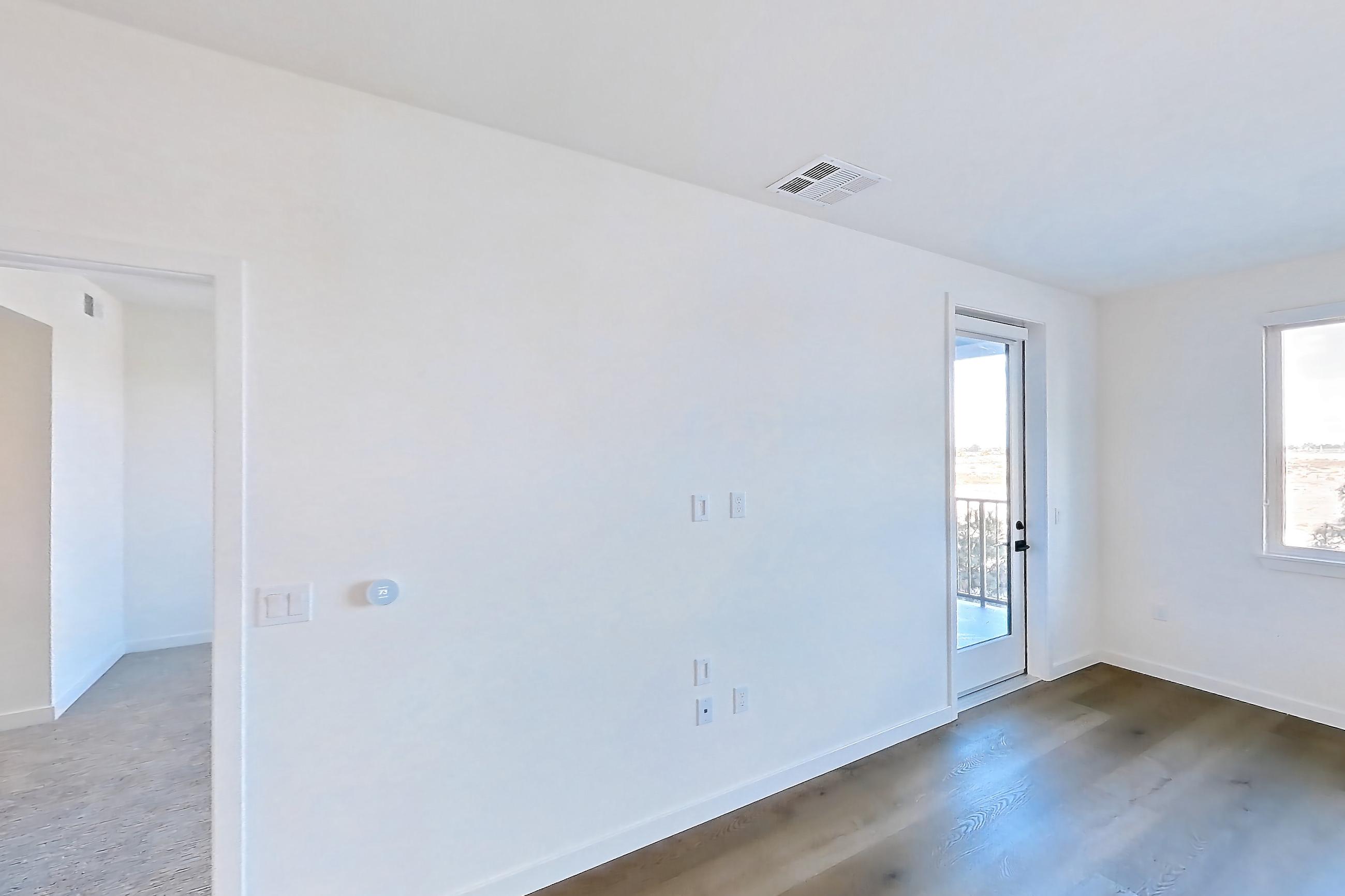 Living room with dark wood-finish flooring and light wood-finish flooring, Apartment 1208 at VAYA on Axia