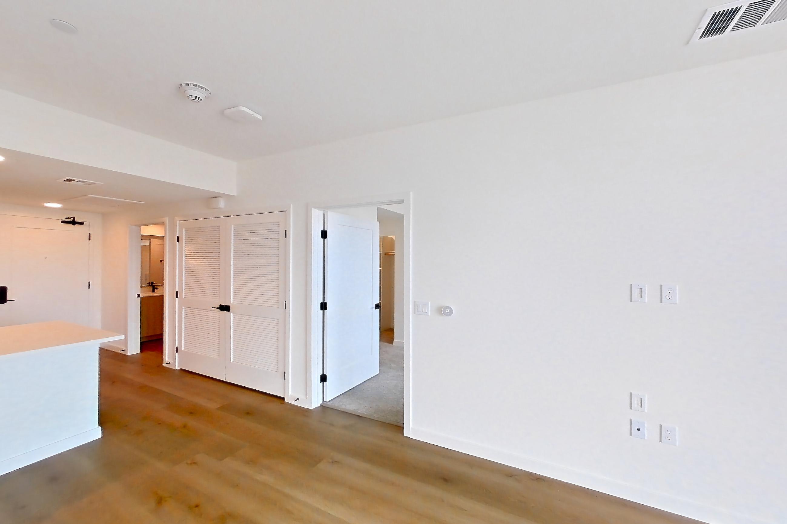 Living room with light wood-finish flooring, Apartment 1405 at VAYA on Axia
