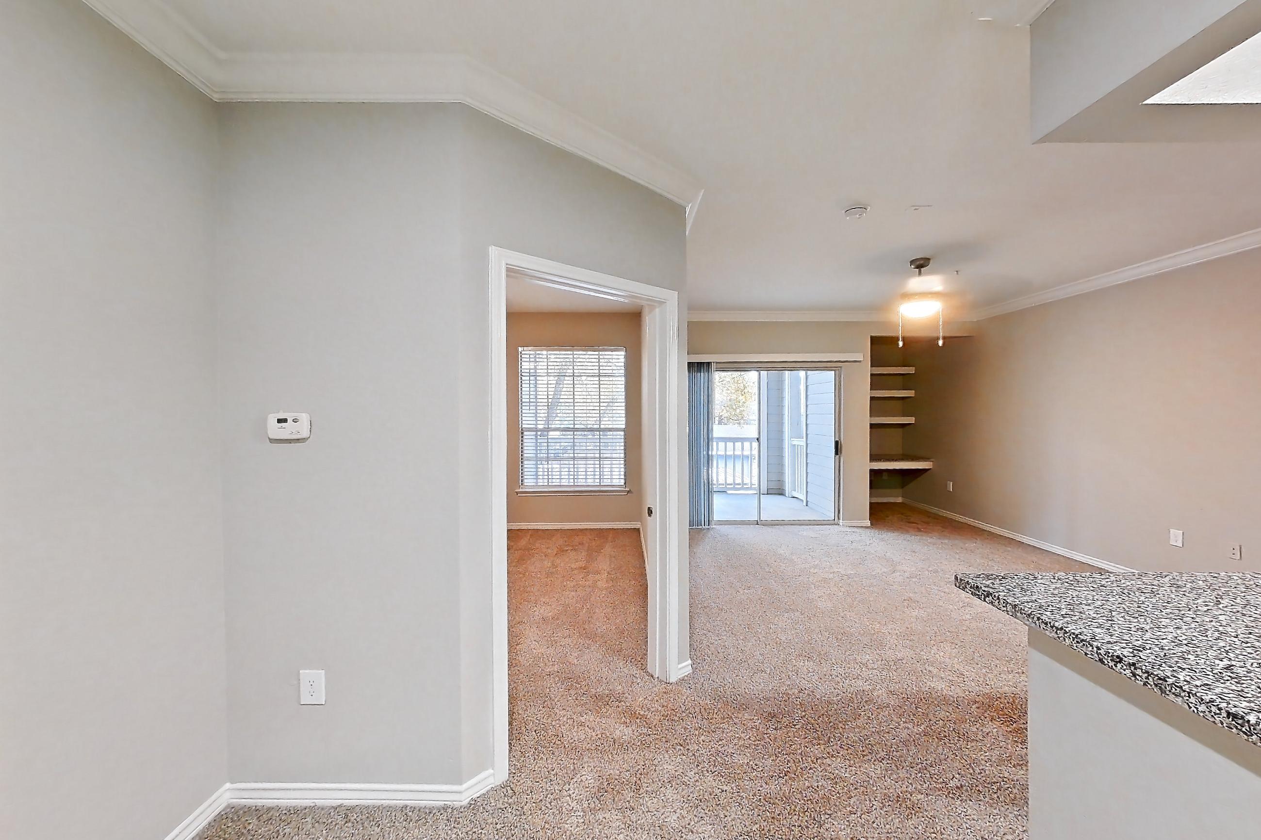 Dining room with dishwasher, electric range, kitchen island, light carpet, light stone countertops, light wood-finish flooring, oven/range, refrigerator, and stainless steel appliances, Apartment 0222 at Reserve at Kingwood