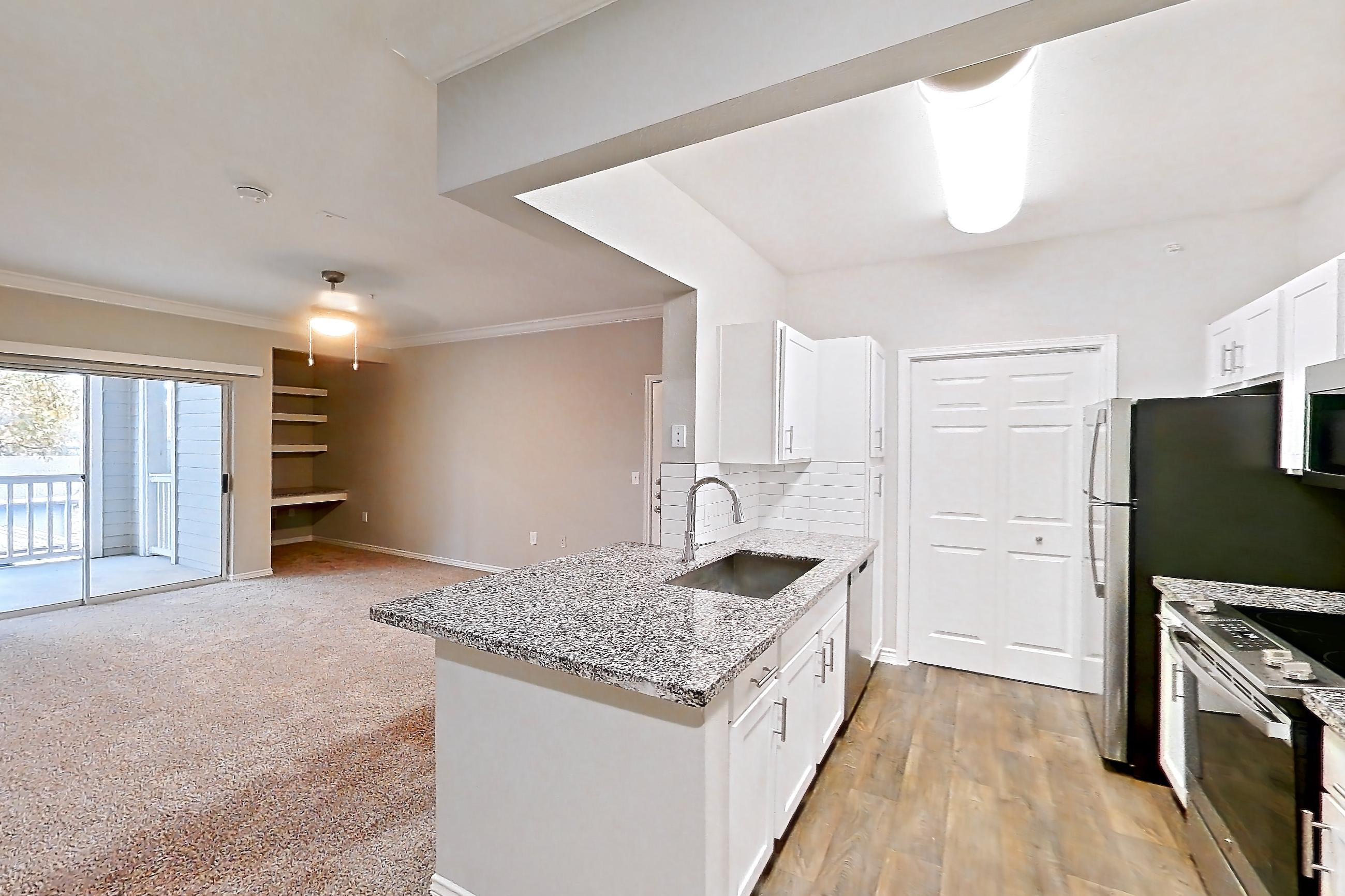 Dining room with dishwasher, electric range, kitchen island, light carpet, light stone countertops, light wood-finish flooring, oven/range, refrigerator, and stainless steel appliances, Apartment 0222 at Reserve at Kingwood