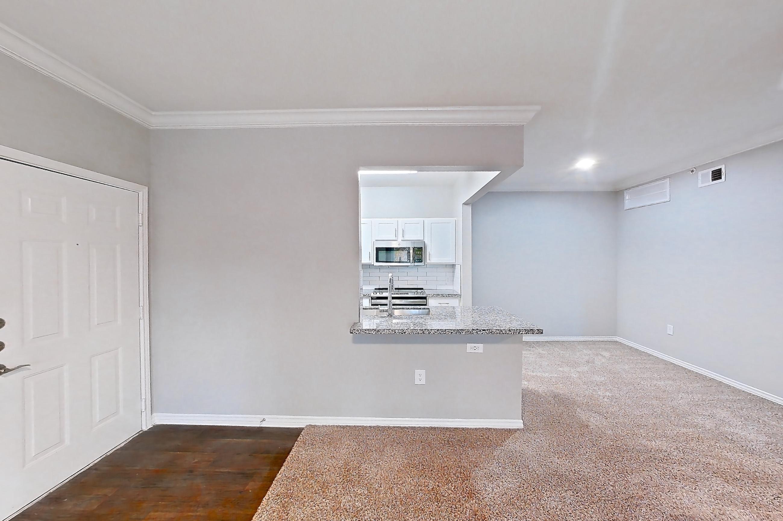 Living room with oven/range and stainless steel appliances, Apartment 0222 at Reserve at Kingwood