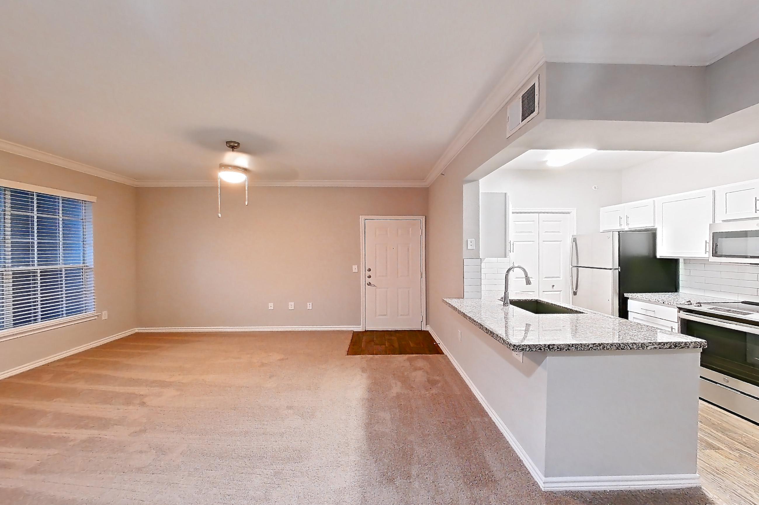 Dining room with electric range, light carpet, light stone countertops, oven/range, refrigerator, and stainless steel appliances, Apartment 0727 at Reserve at Kingwood