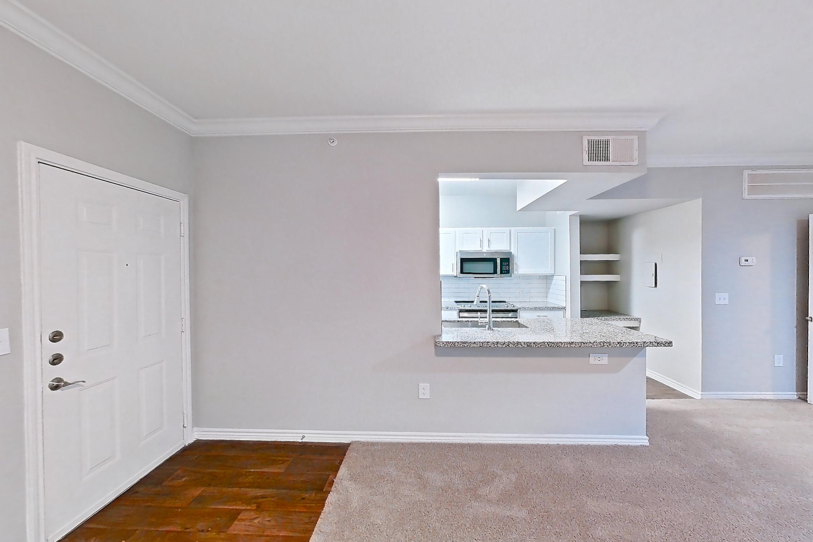Living room with light carpet, oven/range, and stainless steel appliances, Apartment 0727 at Reserve at Kingwood