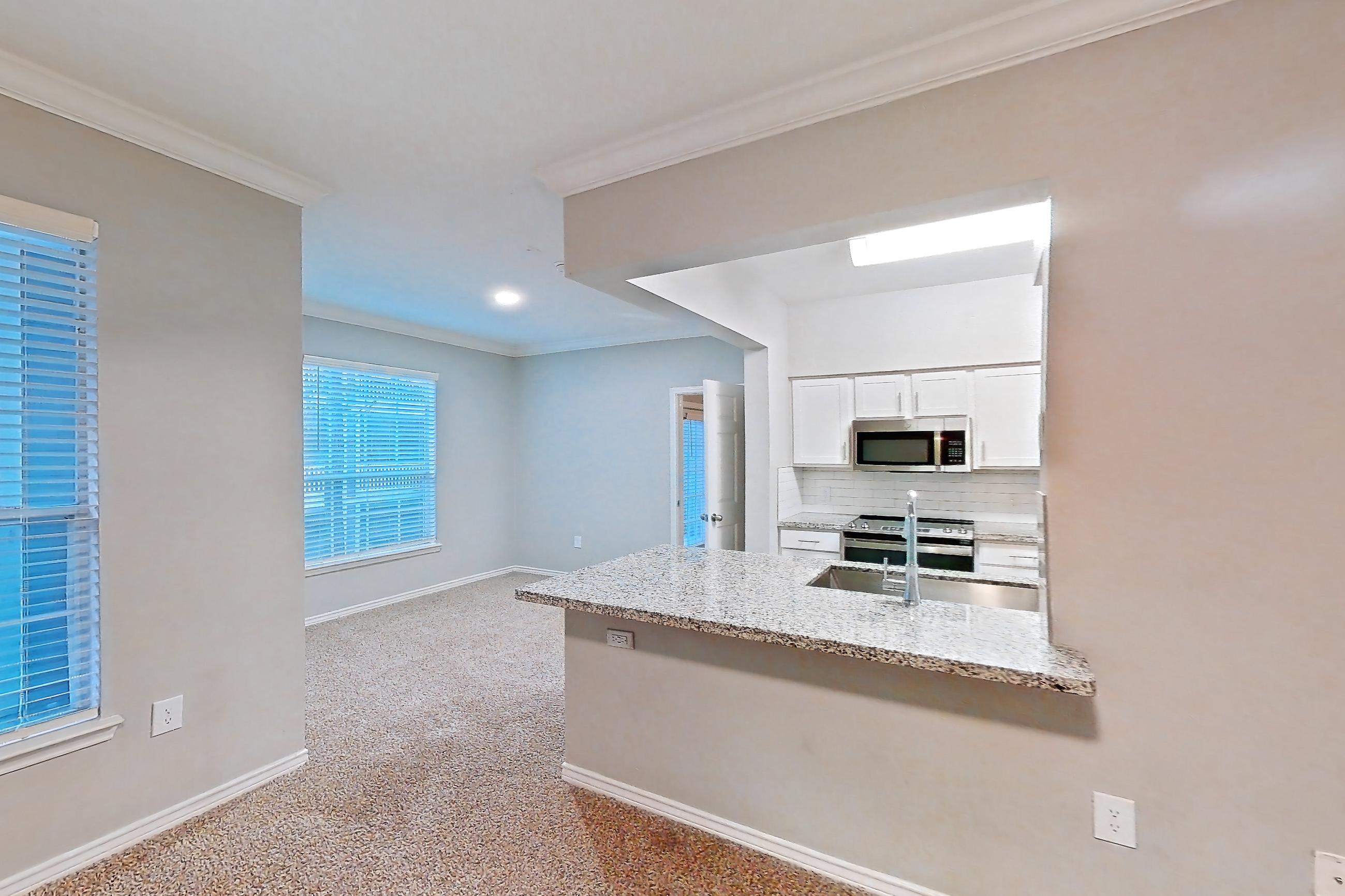 Living room with electric range, light carpet, light stone countertops, oven/range, and stainless steel appliances, Apartment 0920 at Reserve at Kingwood