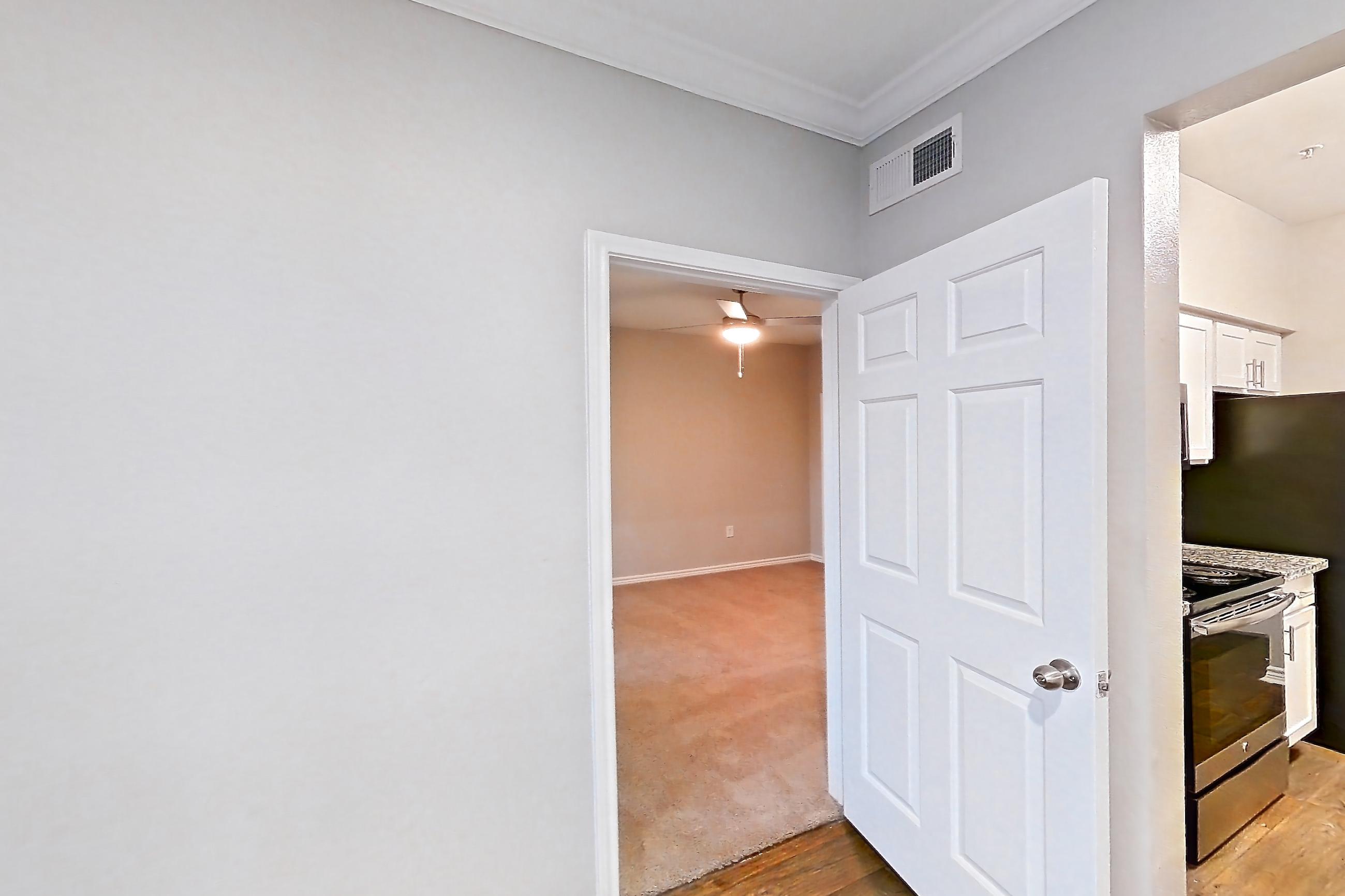 Dining room with dark wood-finish flooring, dishwasher, electric range, light stone countertops, oven/range, refrigerator, and stainless steel appliances, Apartment 1115 at Reserve at Kingwood