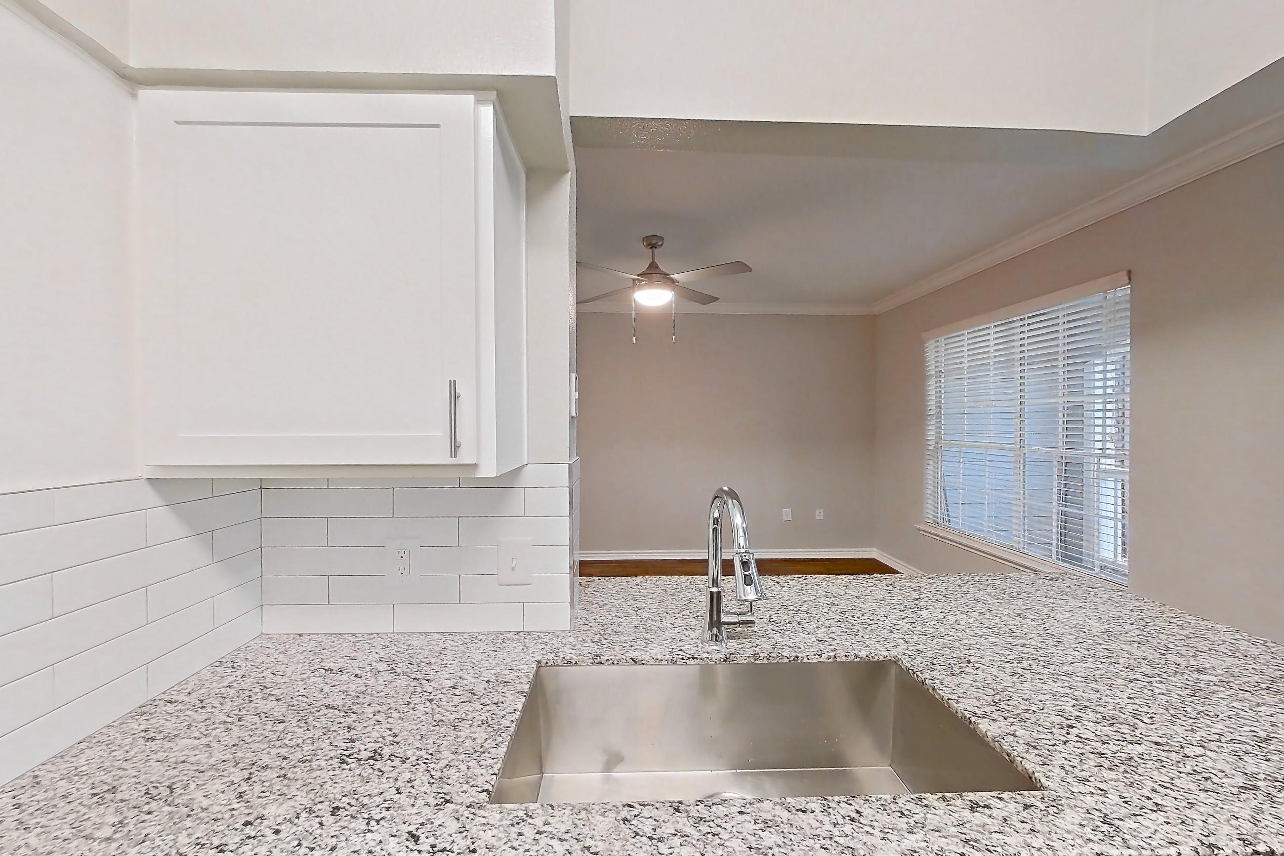 Kitchen with dark wood-finish flooring, dishwasher, electric range, glass shower door, light stone countertops, oven/range, refrigerator, stainless steel appliances, stall shower, and walk-in shower, Apartment 1115 at Reserve at Kingwood