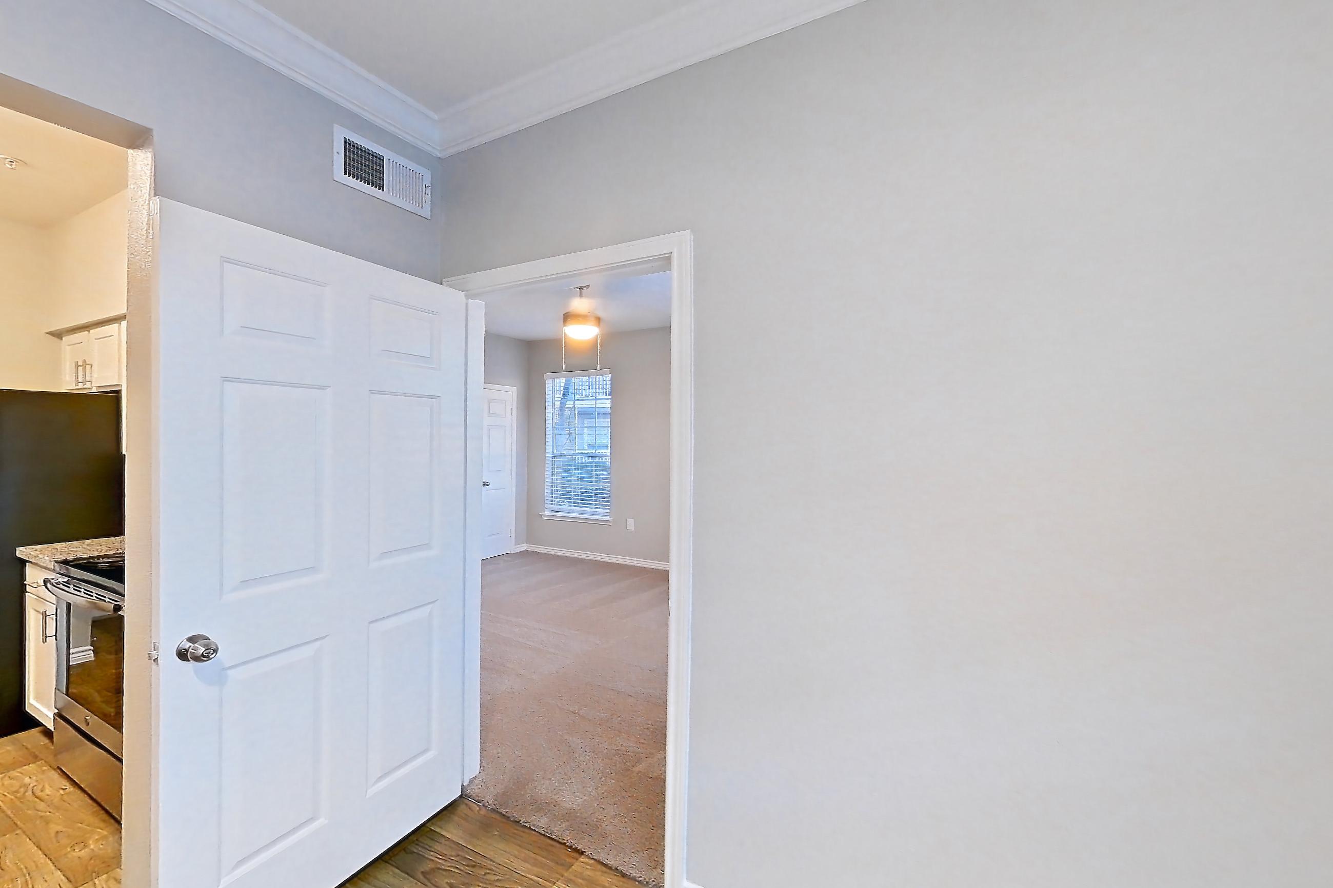Dining room with dishwasher, electric range, light stone countertops, light wood-finish flooring, oven/range, refrigerator, and stainless steel appliances, Apartment 0914 at Reserve at Kingwood