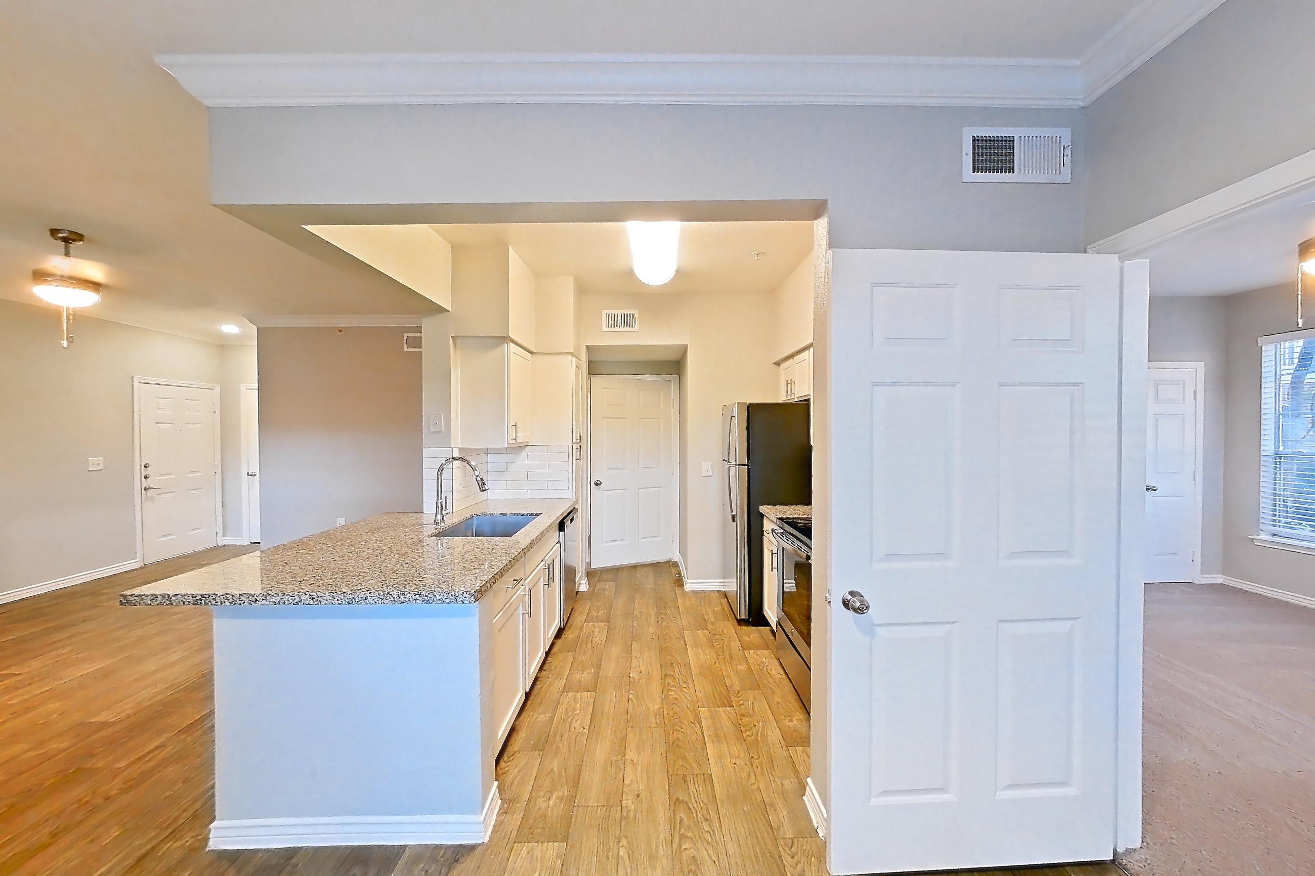 Dining room with dishwasher, electric range, light stone countertops, light wood-finish flooring, oven/range, refrigerator, and stainless steel appliances, Apartment 0914 at Reserve at Kingwood