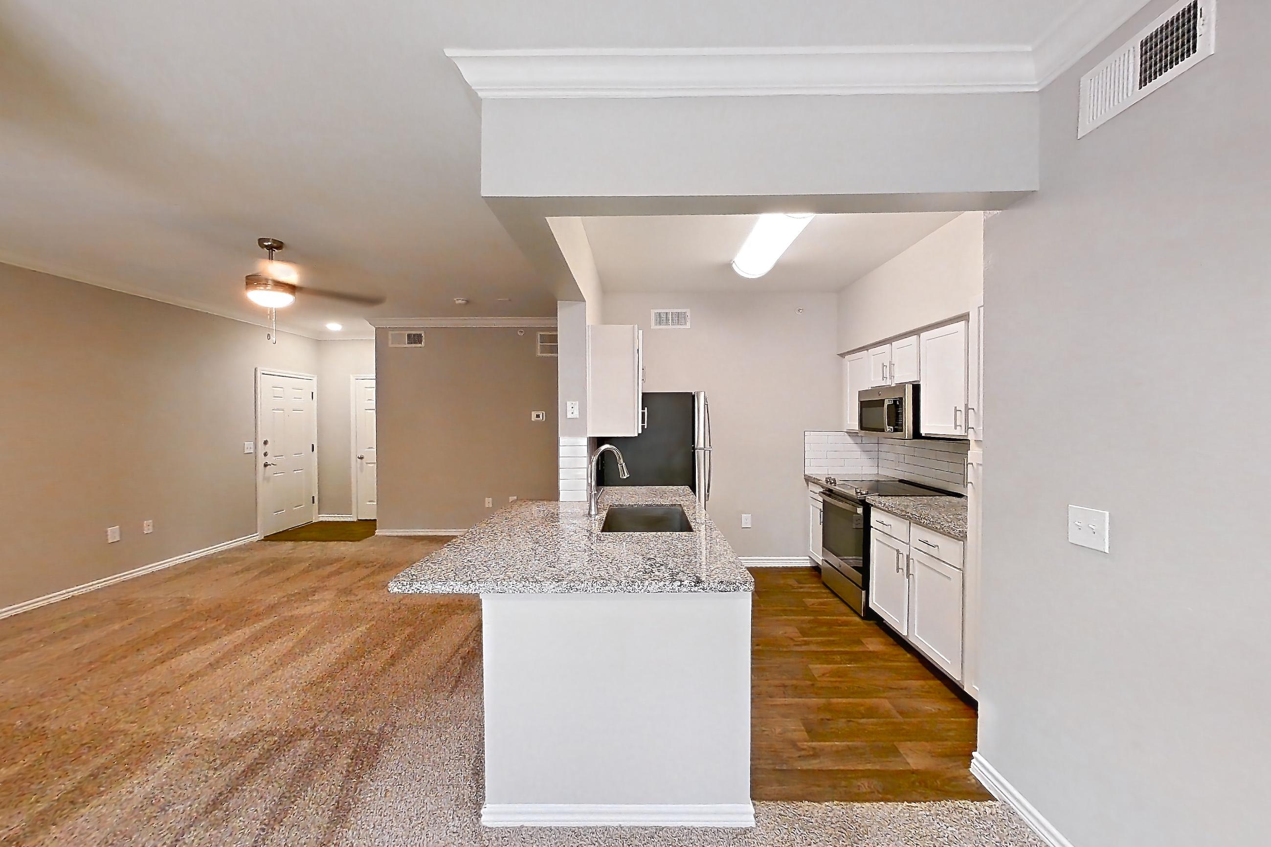 Dining room with dark carpet, electric range, kitchen island, light carpet, light stone countertops, oven/range, and stainless steel appliances, Apartment 0529 at Reserve at Kingwood
