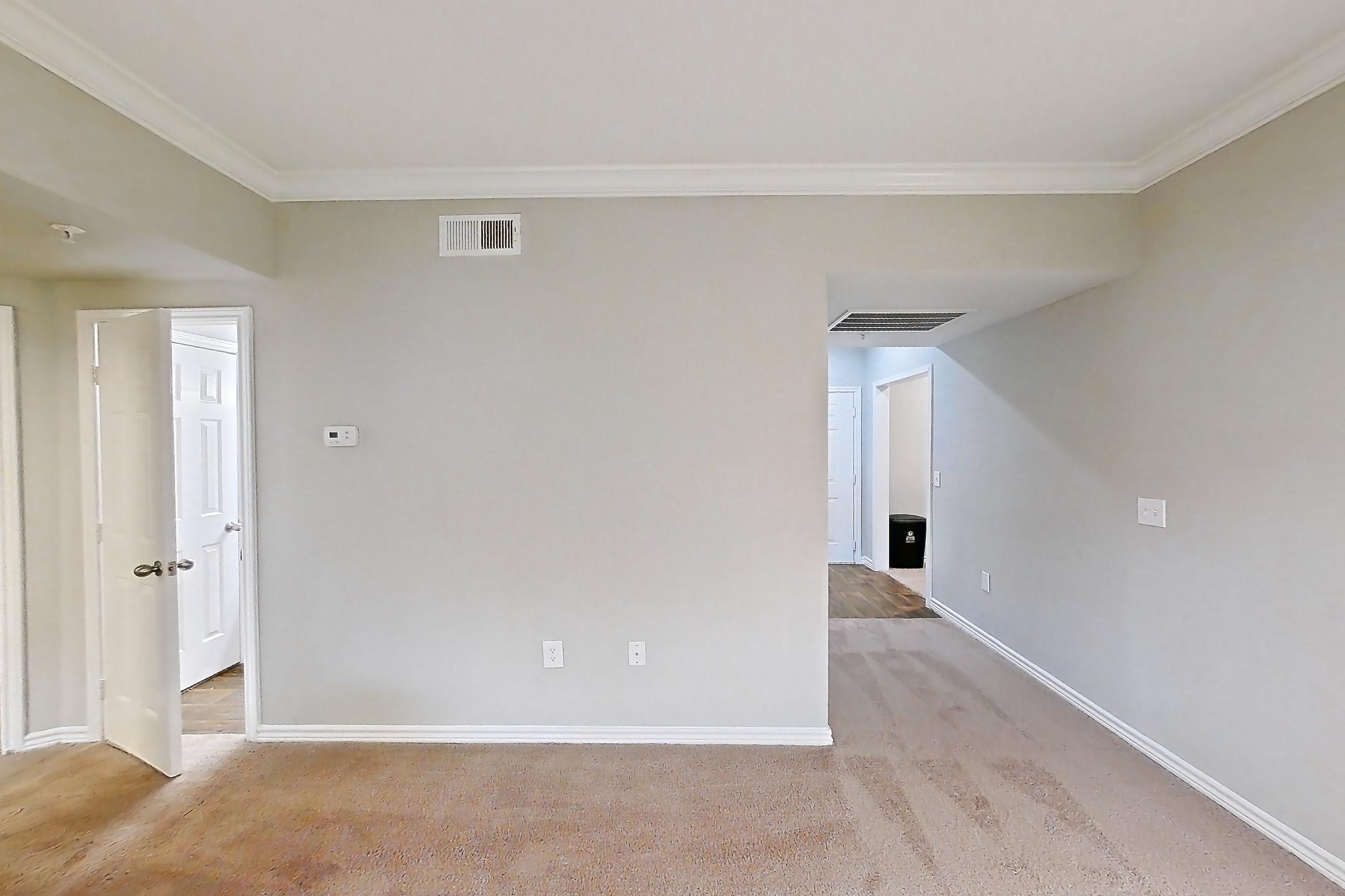 Living room with gas range, kitchen island, light carpet, light stone countertops, and oven/range, Apartment 0828 at Reserve at Kingwood