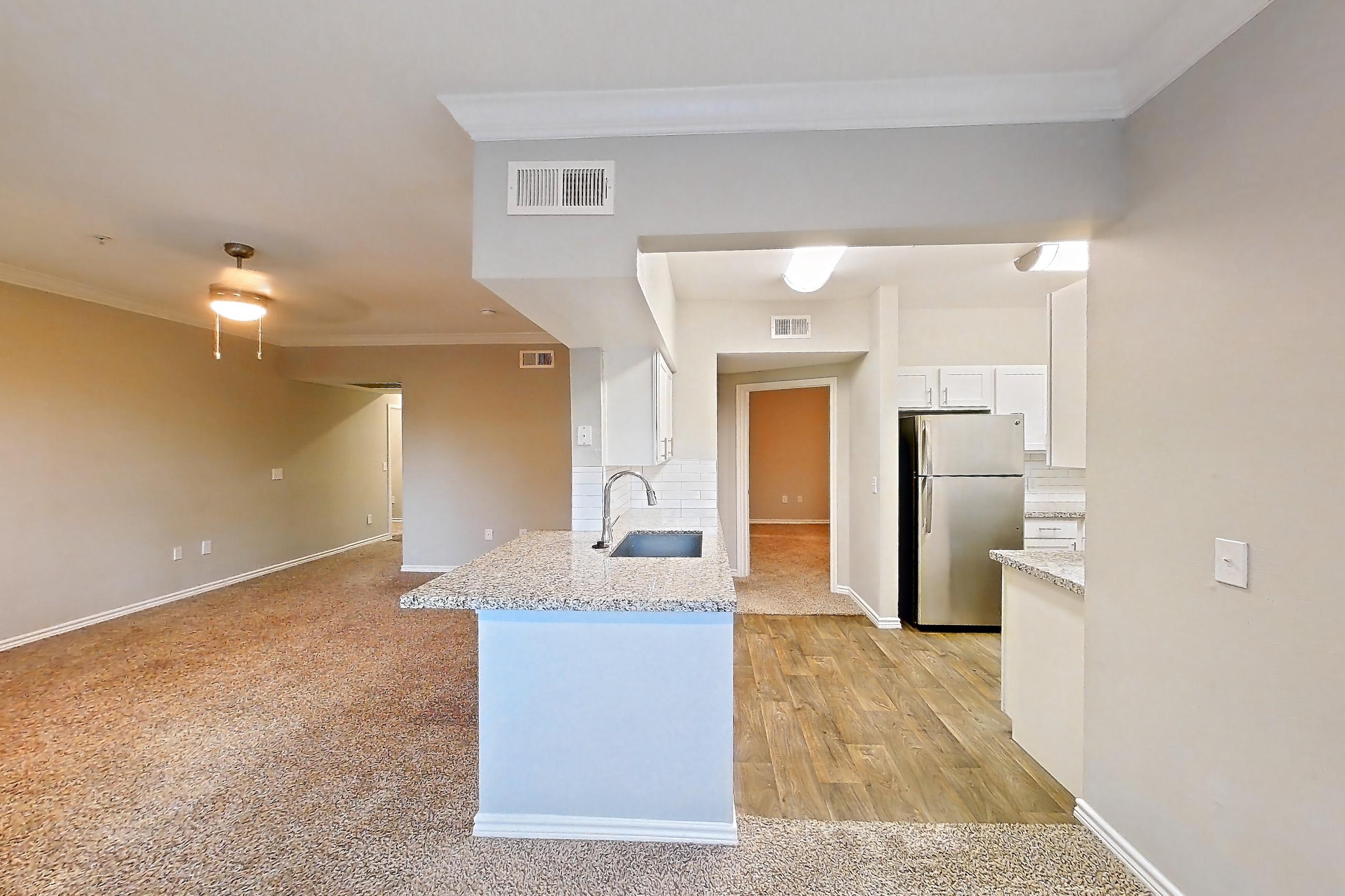 Dining room with light carpet, light stone countertops, refrigerator, and stainless steel appliances, Apartment 0825 at Reserve at Kingwood