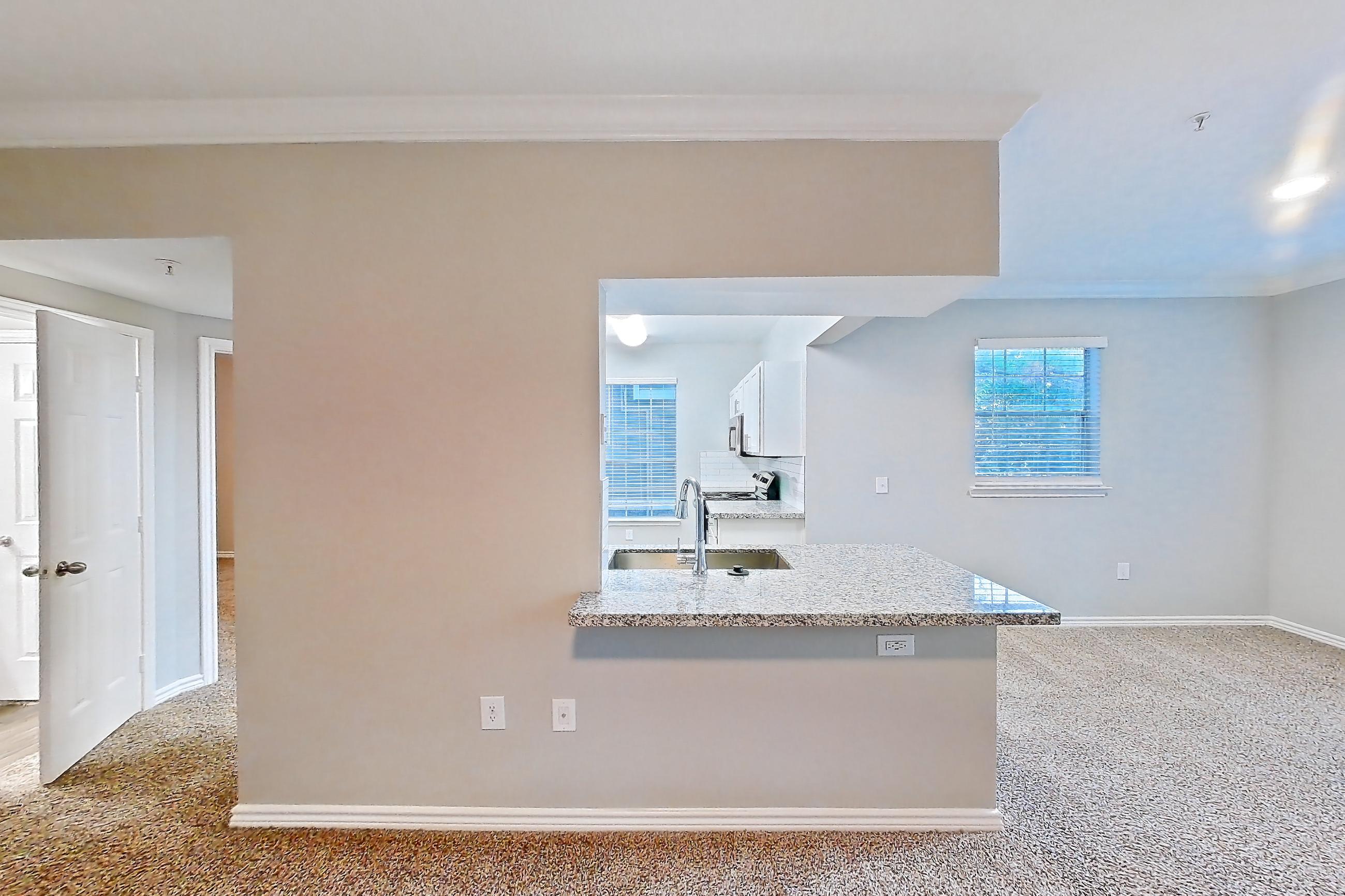Living room with light carpet and light stone countertops, Apartment 0825 at Reserve at Kingwood