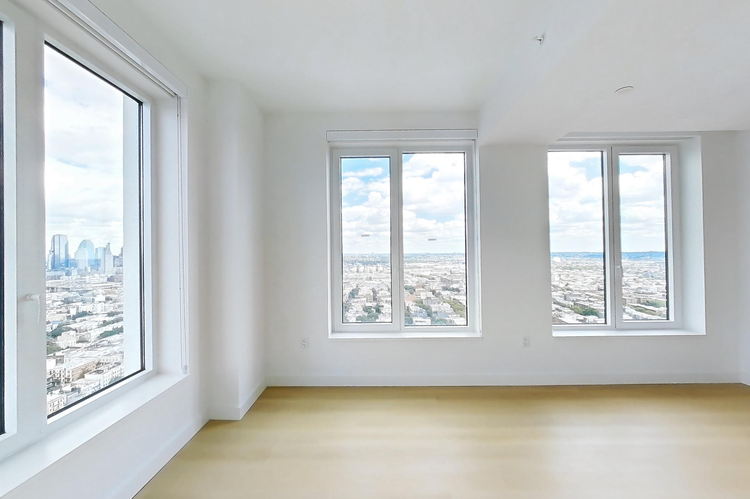 Living room with city view and light wood-finish flooring, Apartment 3411S at The Riverie