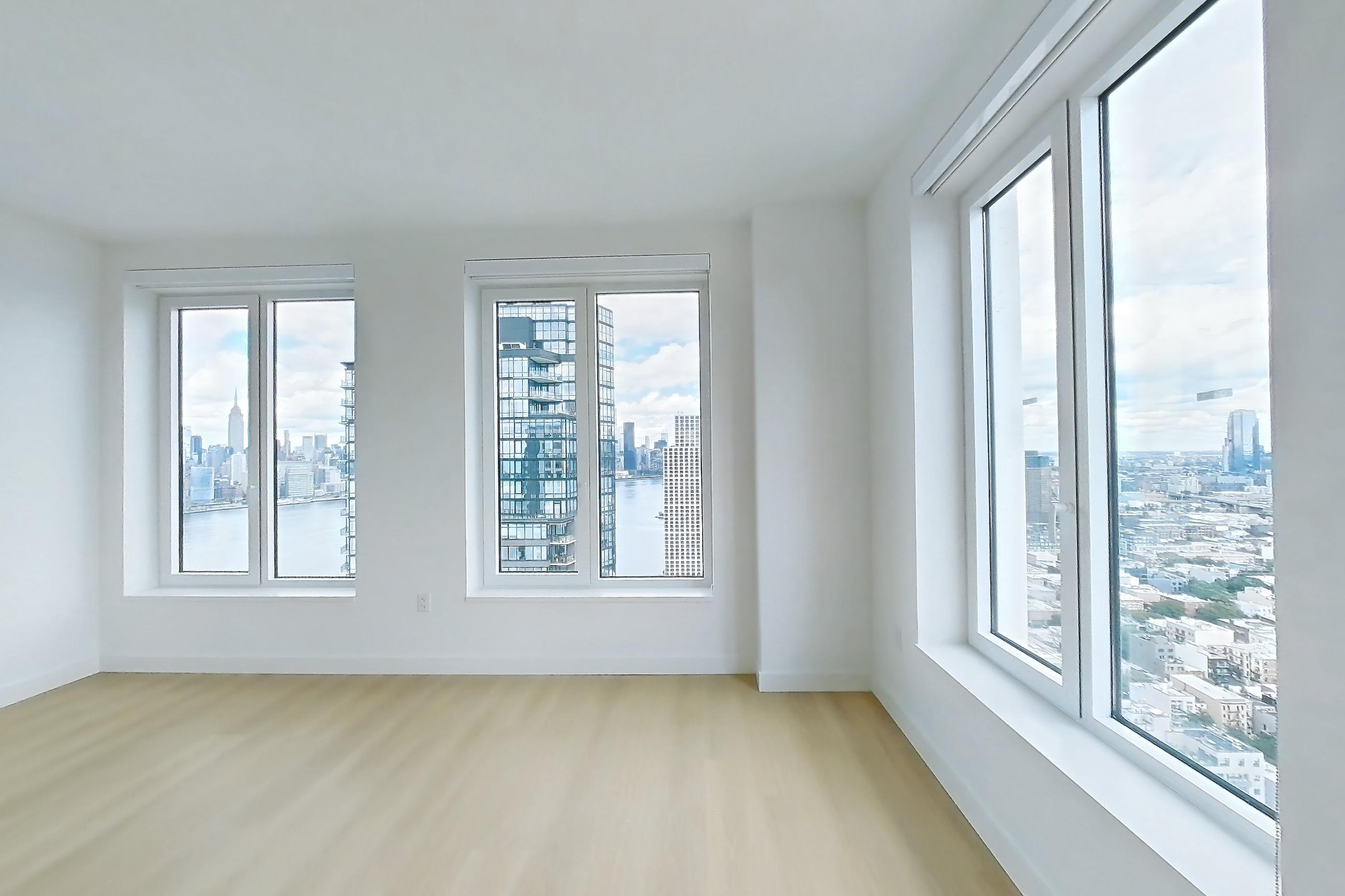 Living space with light wood-finish flooring, Apartment 3411S at The Riverie