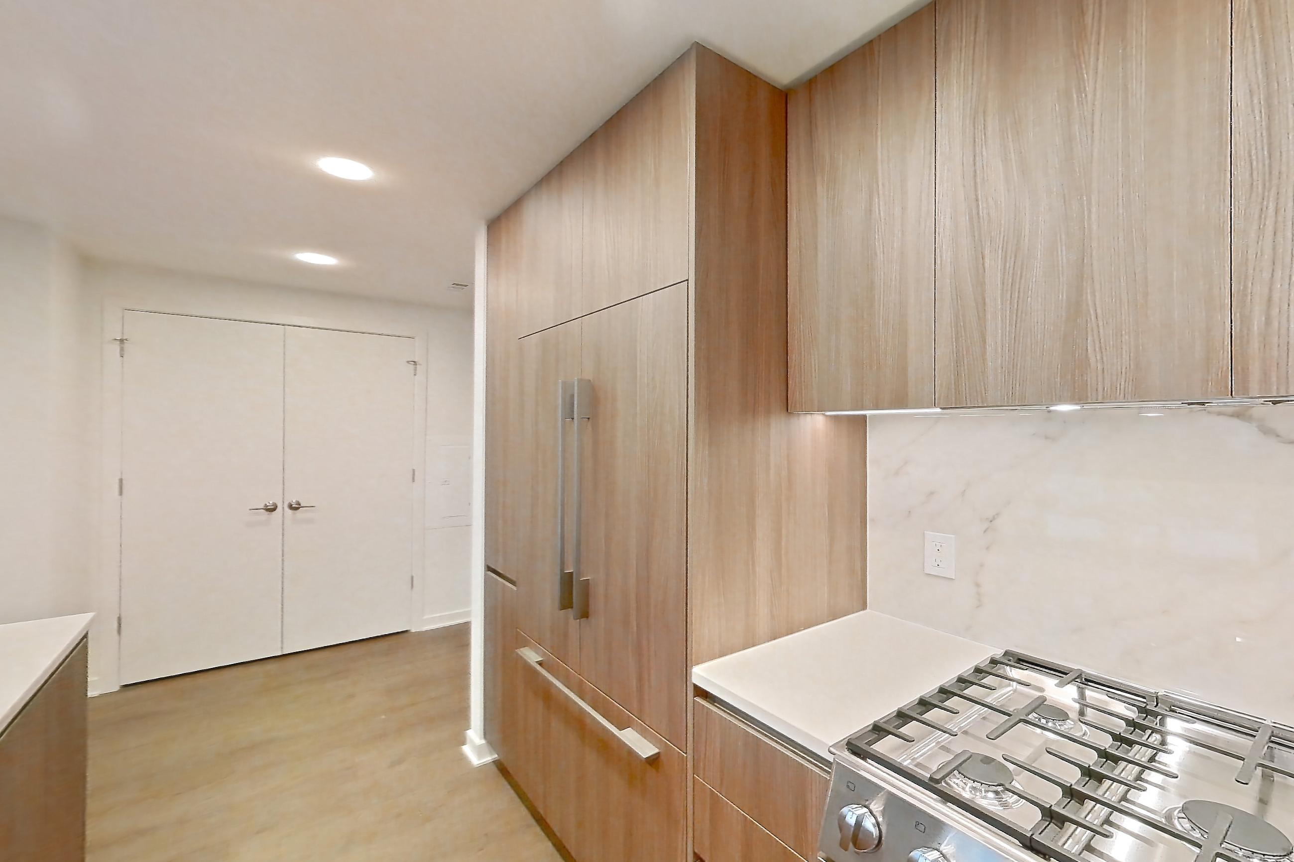 Kitchen with gas range, light stone countertops, light tile flooring, light wood-finish flooring, oven/range, stainless steel appliances, and wood-finish flooring, Apartment 0320 at Aerie
