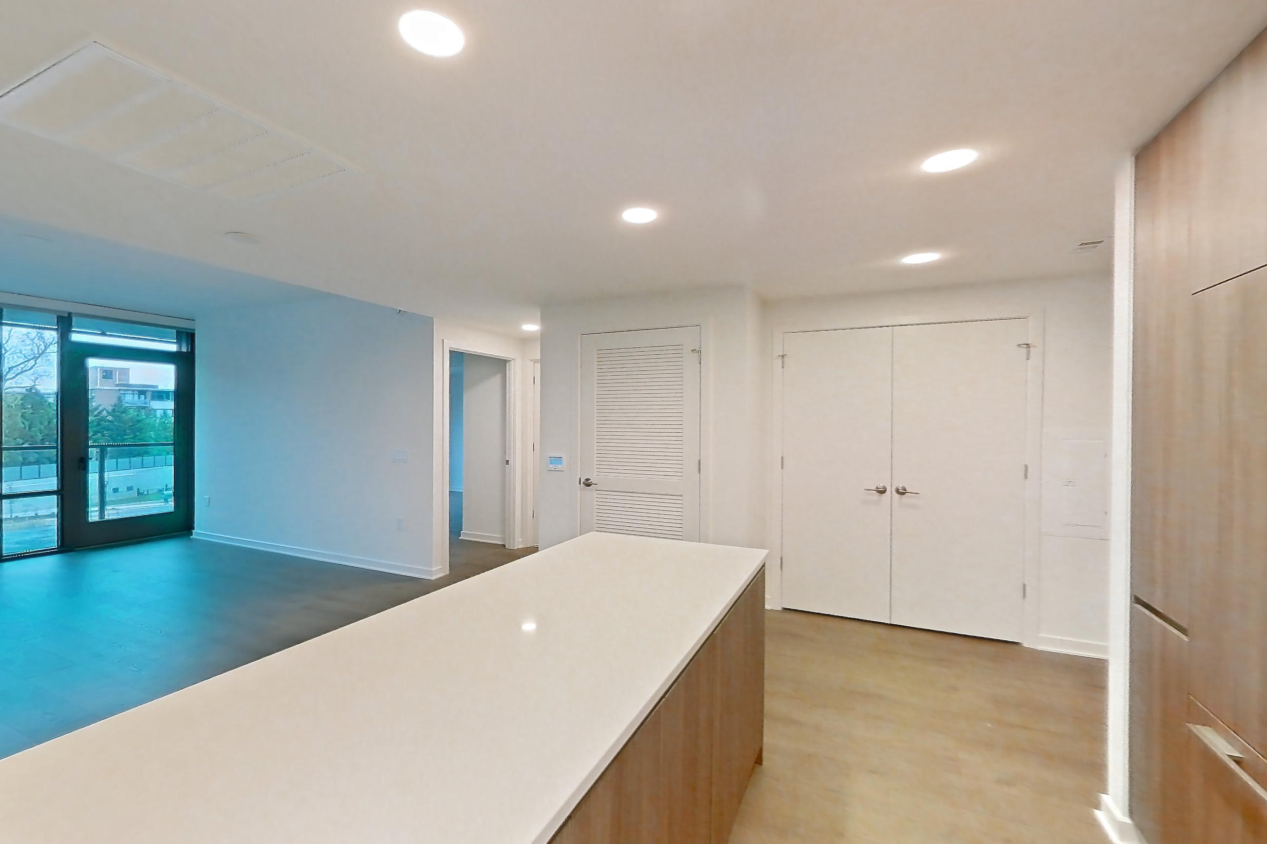 Kitchen with gas range, light stone countertops, light tile flooring, light wood-finish flooring, oven/range, stainless steel appliances, and wood-finish flooring, Apartment 0320 at Aerie