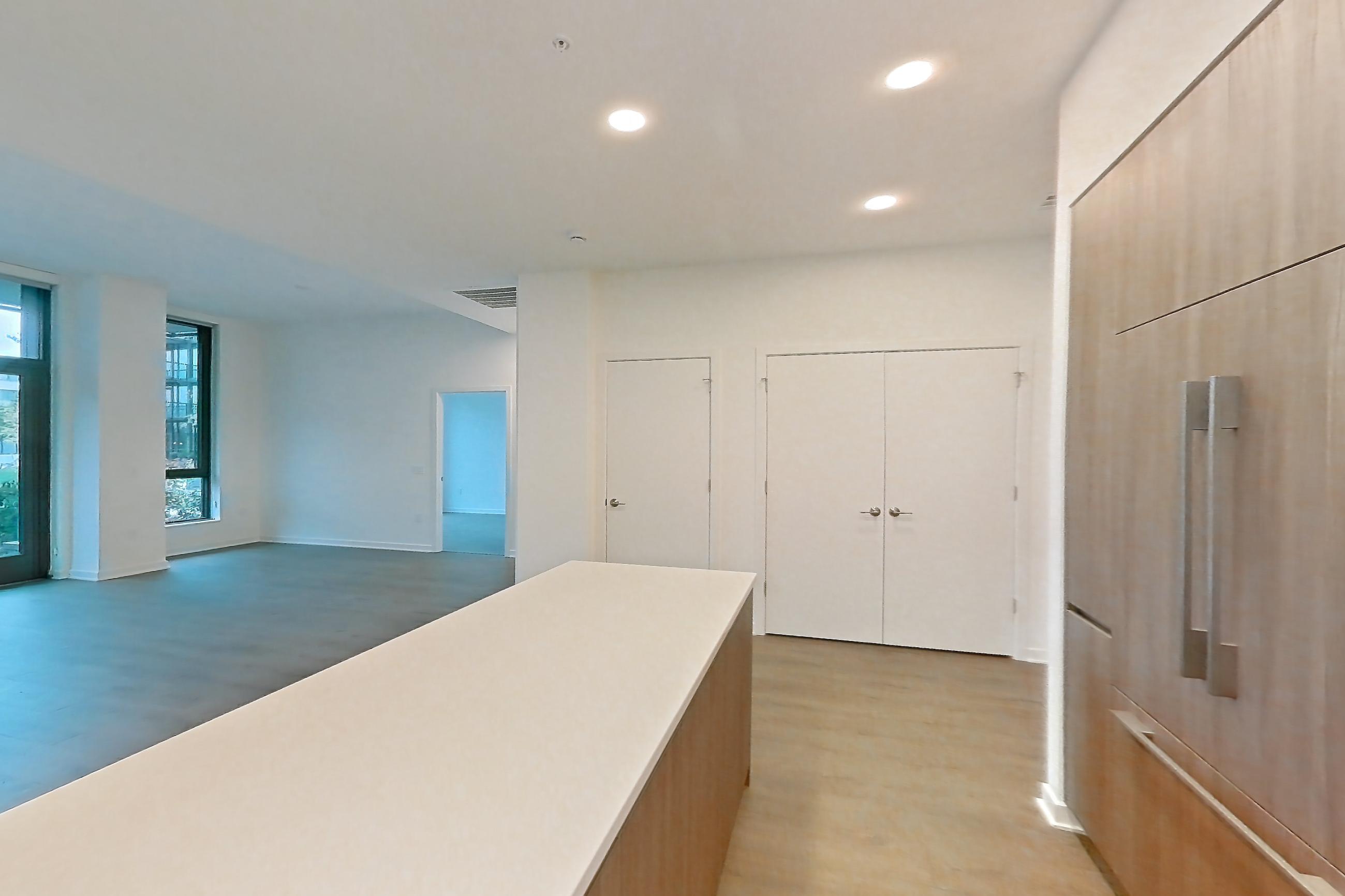 Kitchen with gas range, light stone countertops, light wood-finish flooring, oven/range, and stainless steel appliances, Apartment 0120 at Aerie