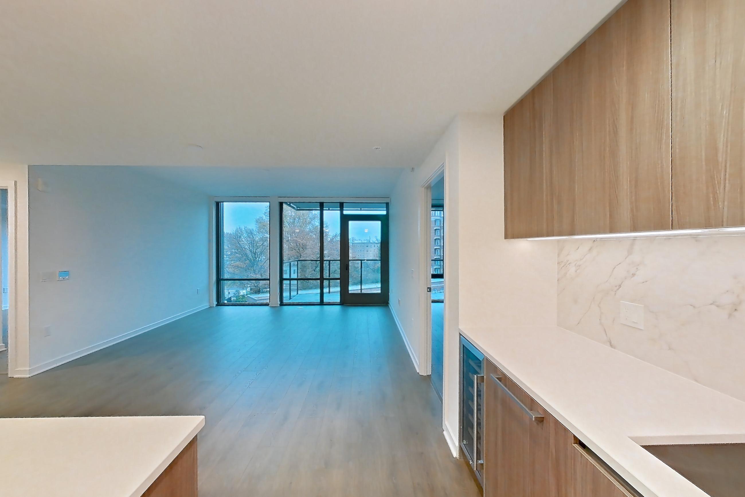 Kitchen with light stone countertops, light wood-finish flooring, oven/range, and stainless steel appliances, Apartment 0515 at Aerie