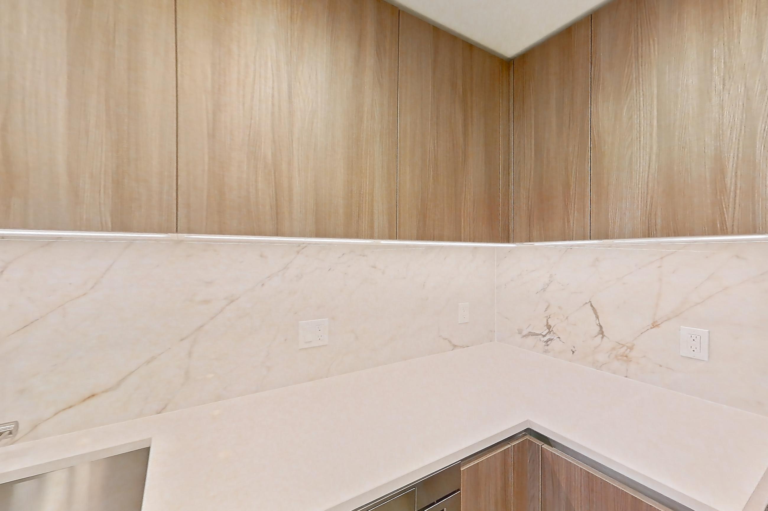 Kitchen with light stone countertops, light wood-finish flooring, oven/range, and stainless steel appliances, Apartment 0515 at Aerie