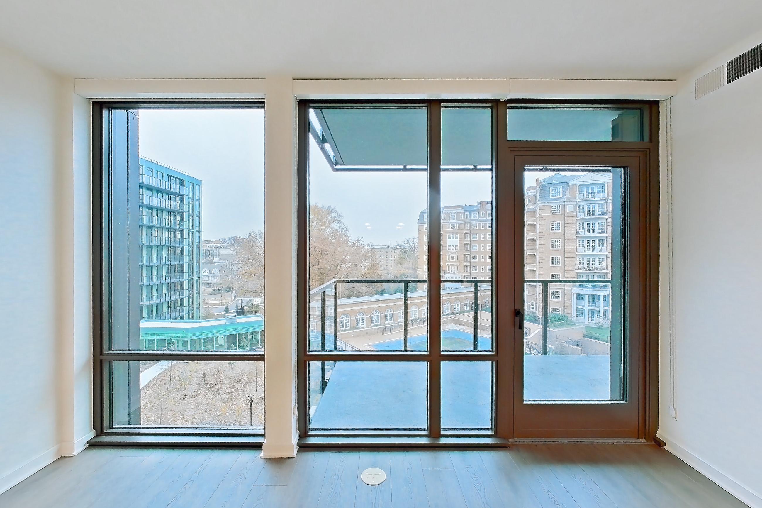 Living room with city view and light wood-finish flooring, Apartment 0515 at Aerie