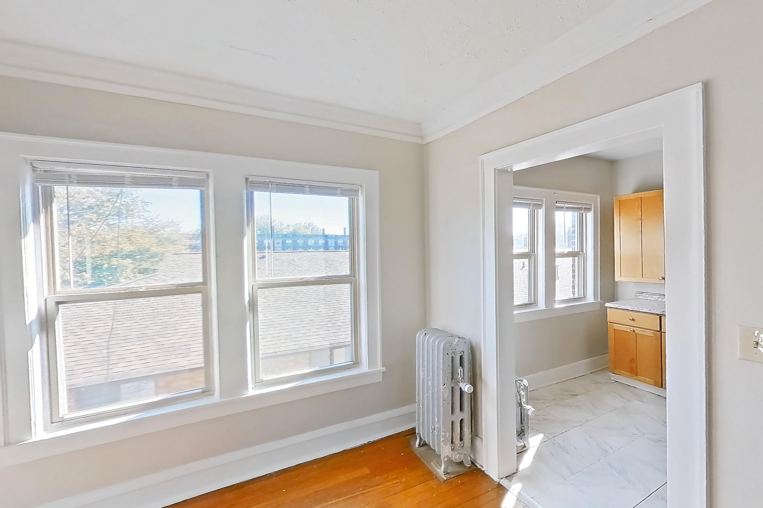Dining room with light wood-finish flooring and wood-finish flooring, Apartment 95-5 at Integrity Gold Coast