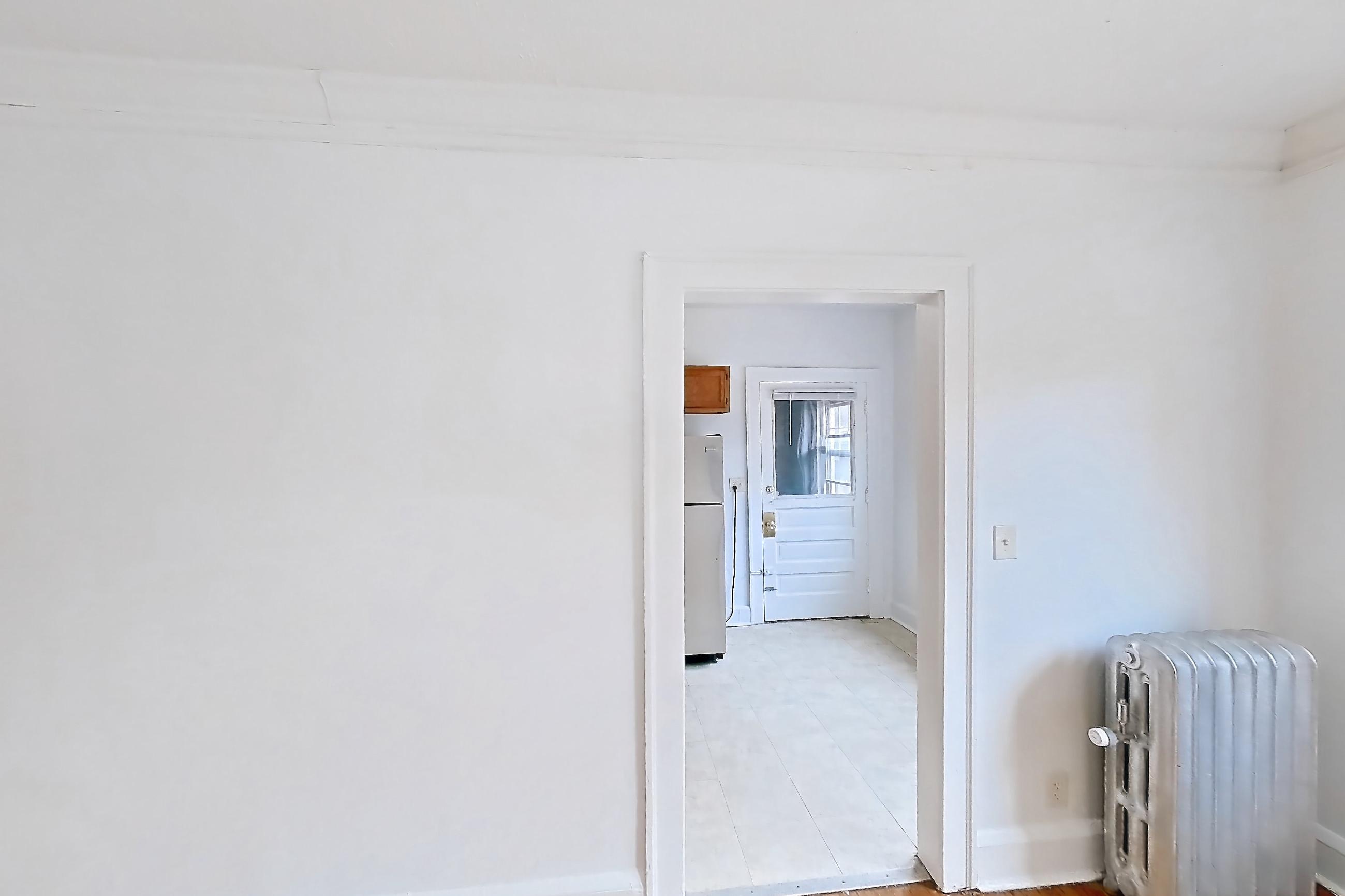 Dining room with light wood-finish flooring, refrigerator, white appliances, and wood-finish flooring, Apartment 95-6 at Integrity Gold Coast