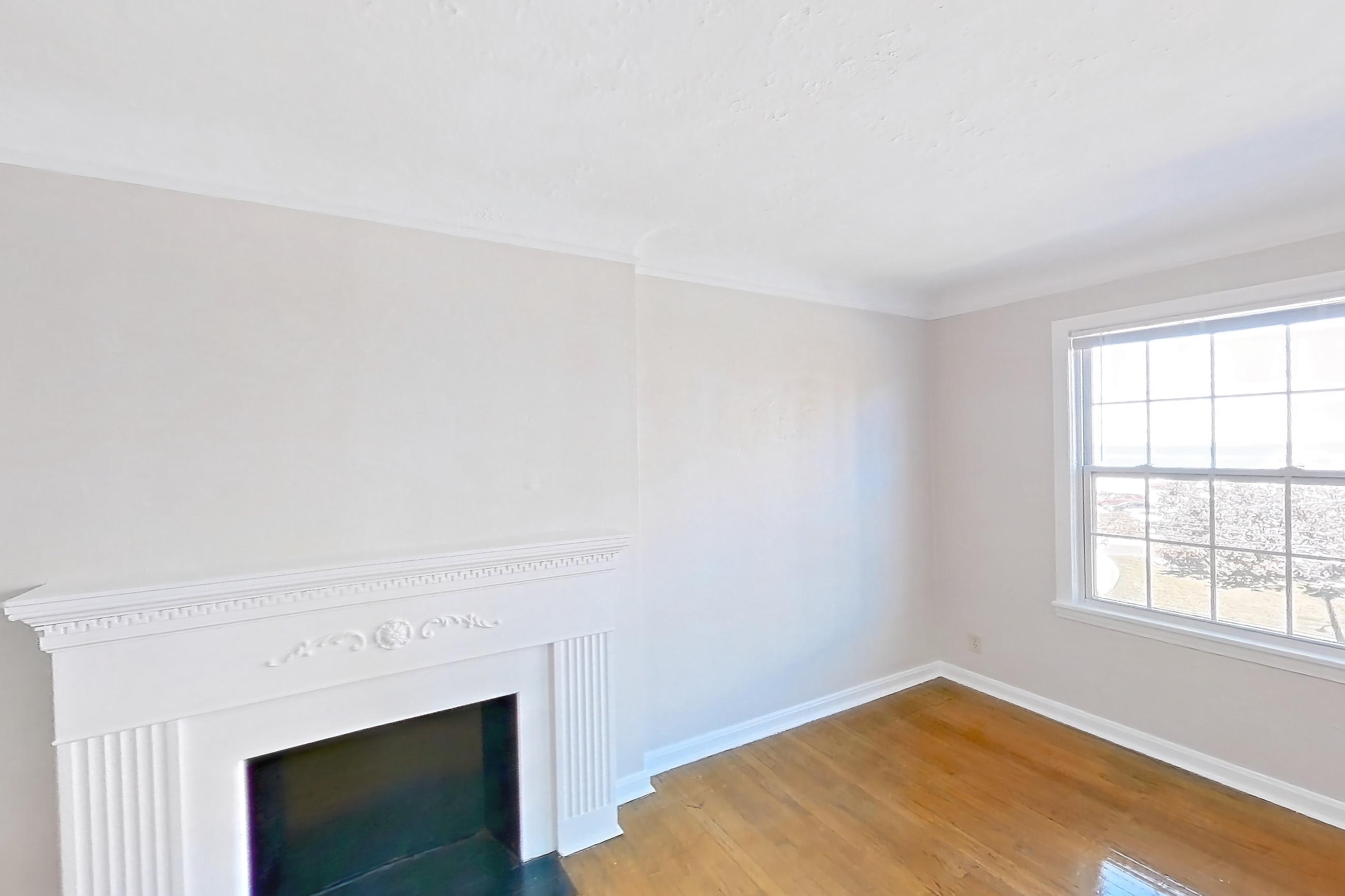 Living room with fireplace, light wood-finish flooring, and wood-finish flooring, Apartment 302 at Integrity Gold Coast