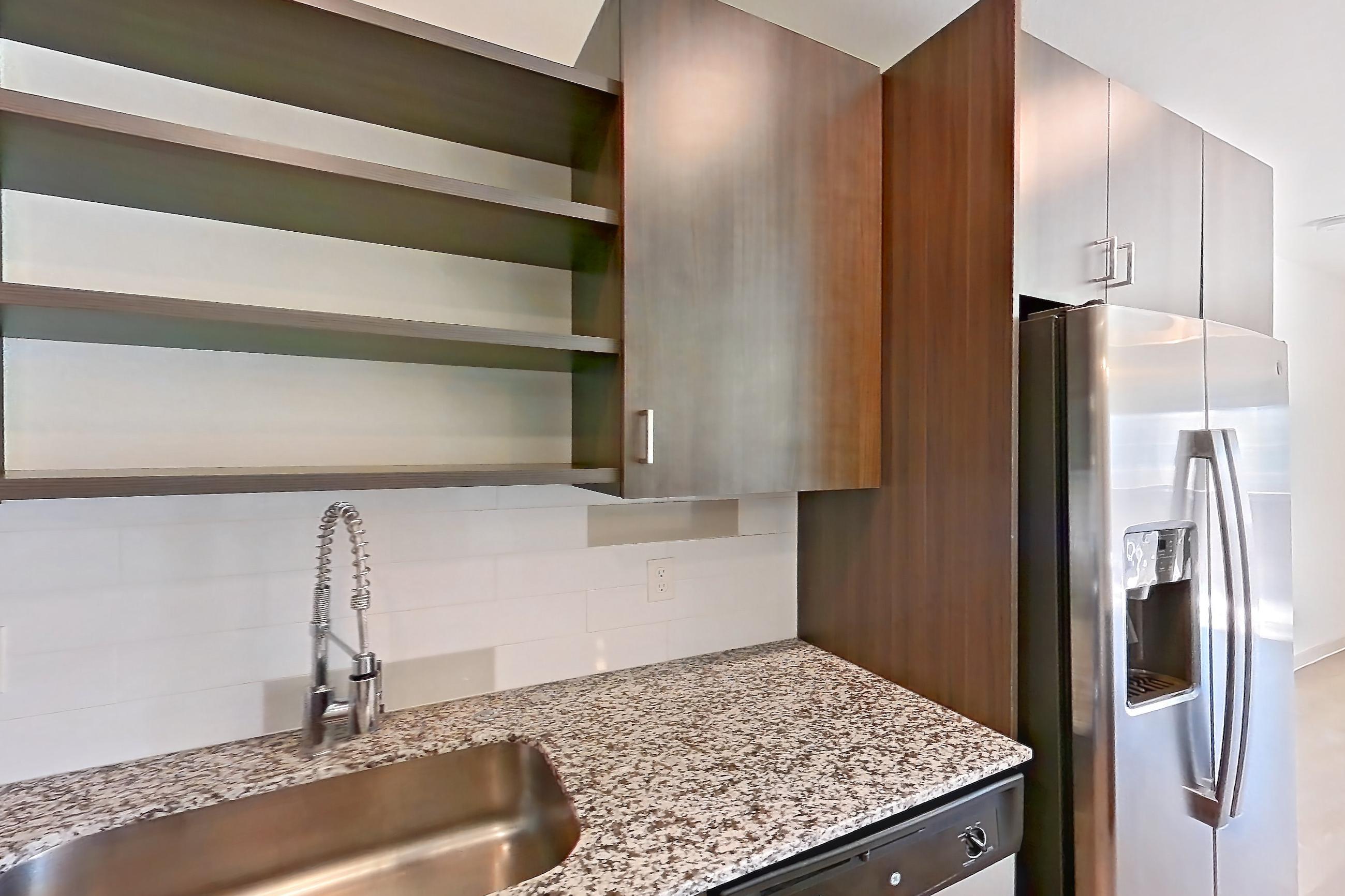 Kitchen with dark wood-finish flooring, dishwasher, electric range, light stone countertops, light wood-finish flooring, microwave, oven/range, and stainless steel appliances, Apartment 1095 at Cortland at P83