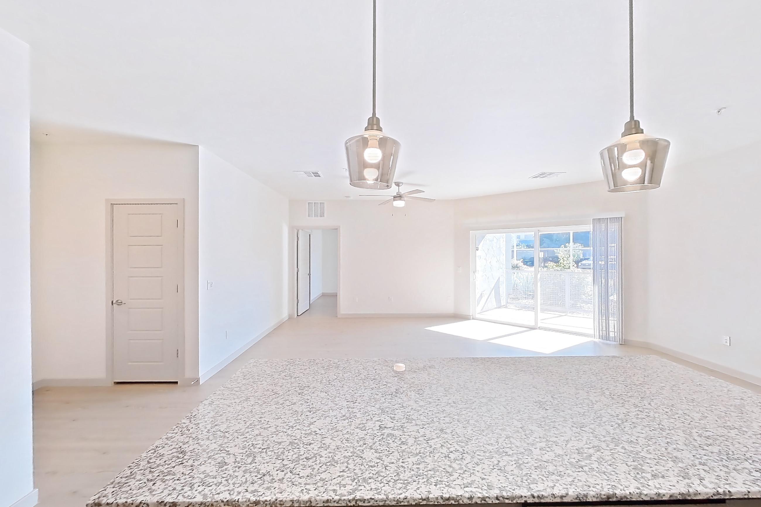 Kitchen with dishwasher, electric range, light stone countertops, light wood-finish flooring, oven/range, refrigerator, stainless steel appliances, and white appliances, Apartment 1097 at Cortland at P83