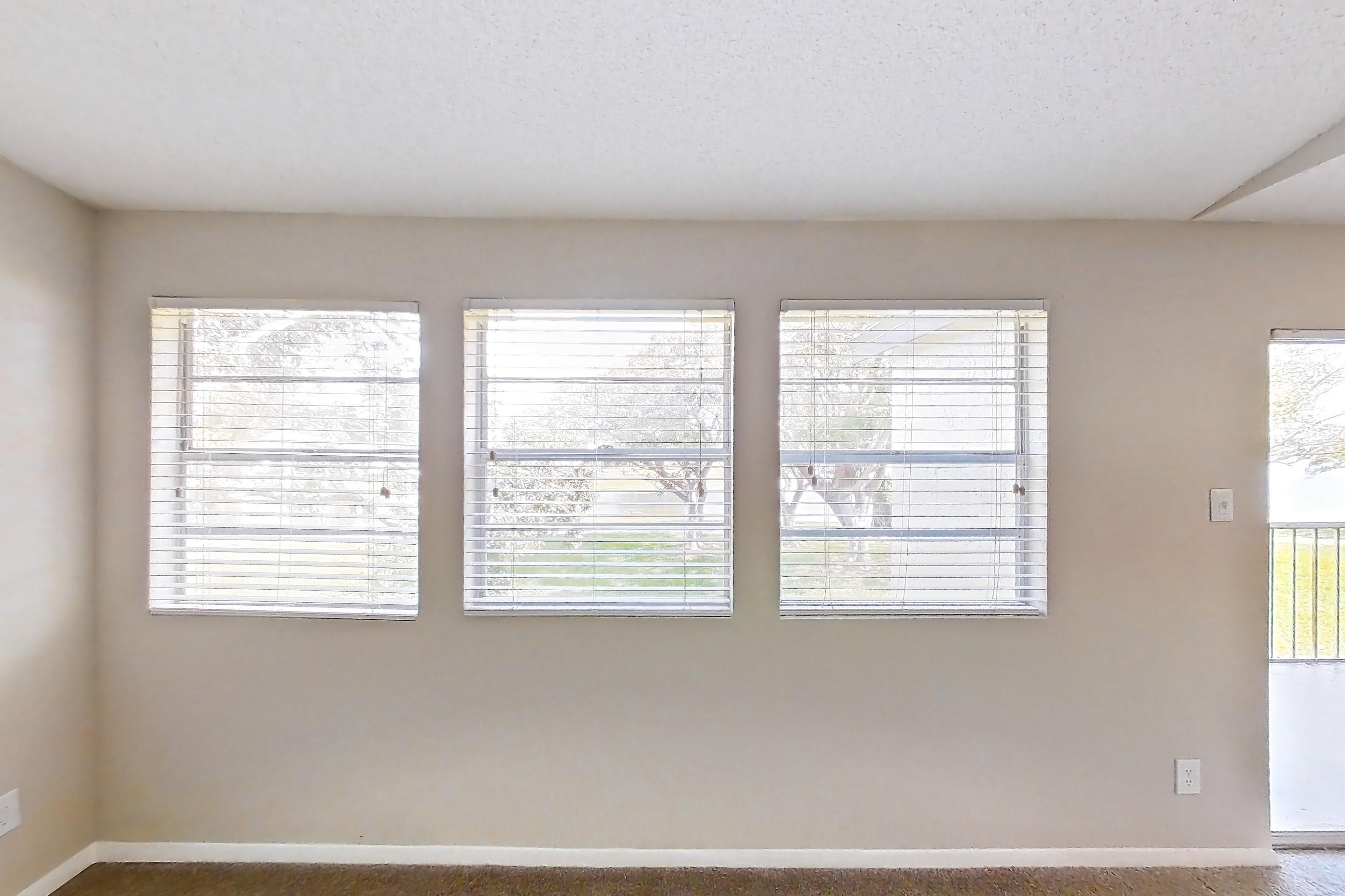 Living room with electric range, light stone countertops, oven/range, refrigerator, and stainless steel appliances, Apartment 1710 at Cortland at the Hammocks