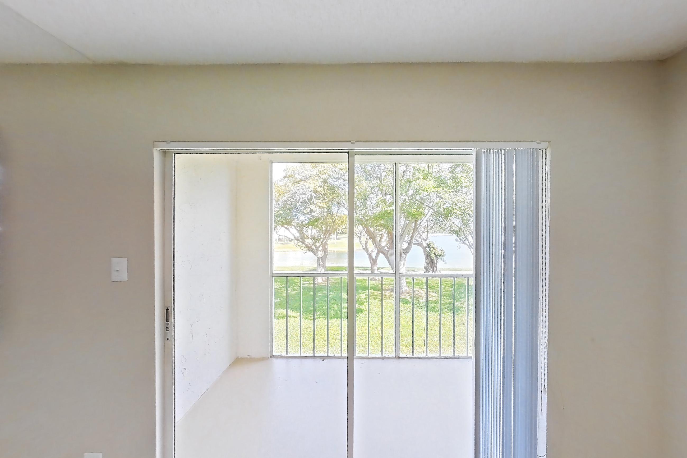 Living space with light carpet and water view, Apartment 1710 at Cortland at the Hammocks
