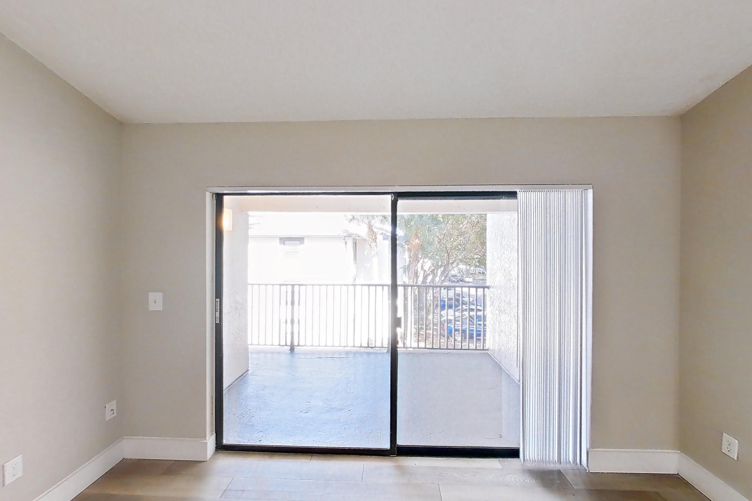 Living room with light wood-finish flooring, Apartment 10-032 at Cortland at the Hammocks