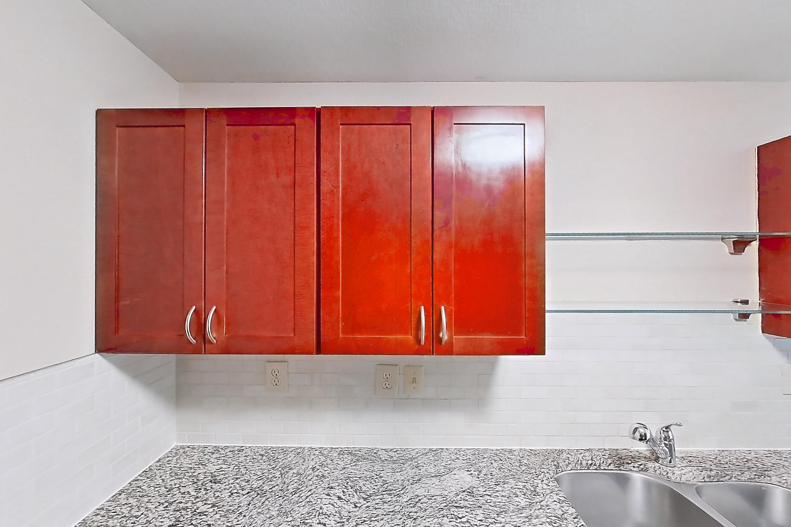 Kitchen with black appliances, dishwasher, electric range, light stone countertops, light wood-finish flooring, microwave, oven/range, and refrigerator, Apartment A-414-3B at Cortland Belmar