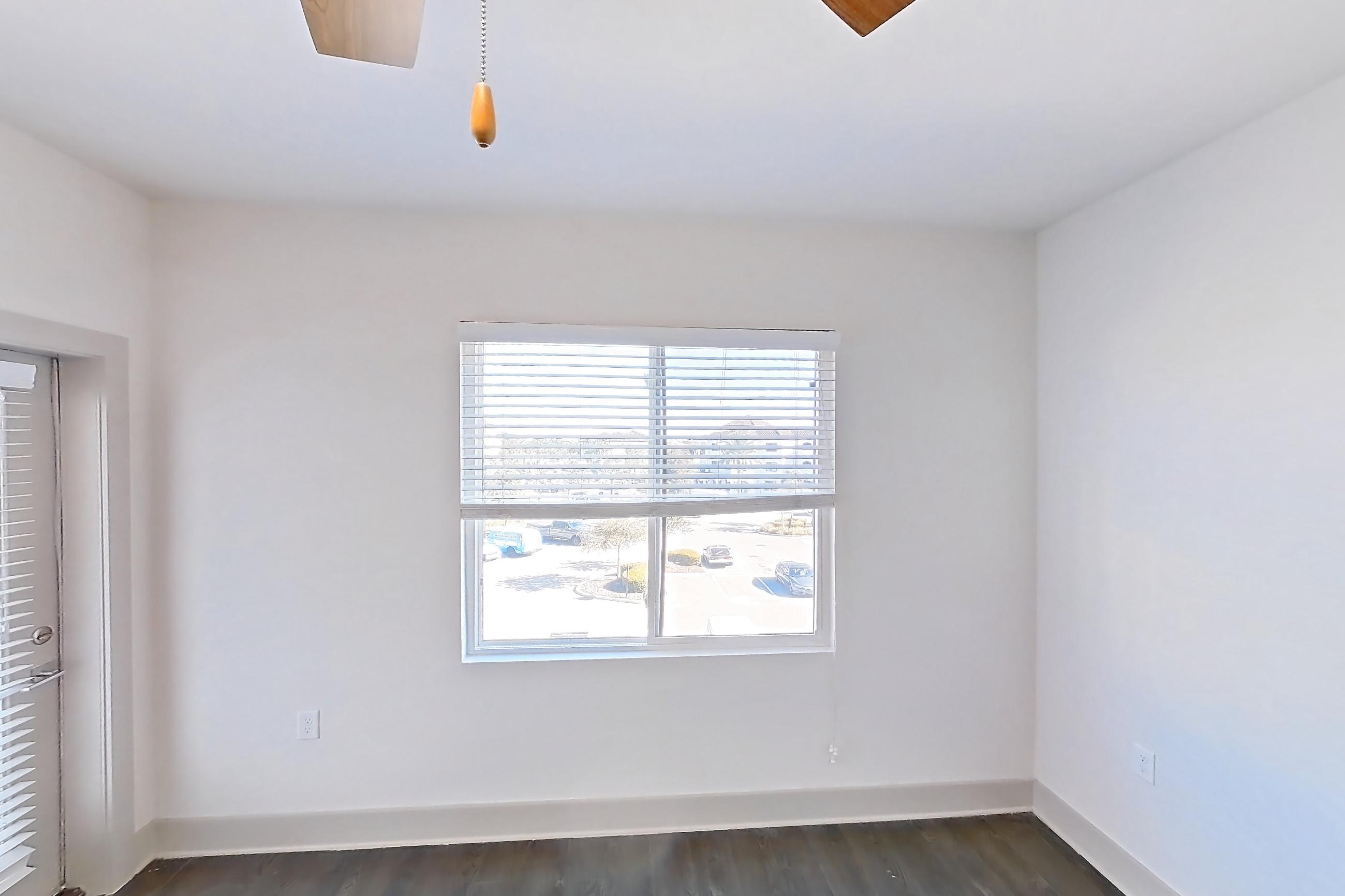 Living room with dark wood-finish flooring, Apartment 2-326 at Cortland Bayport