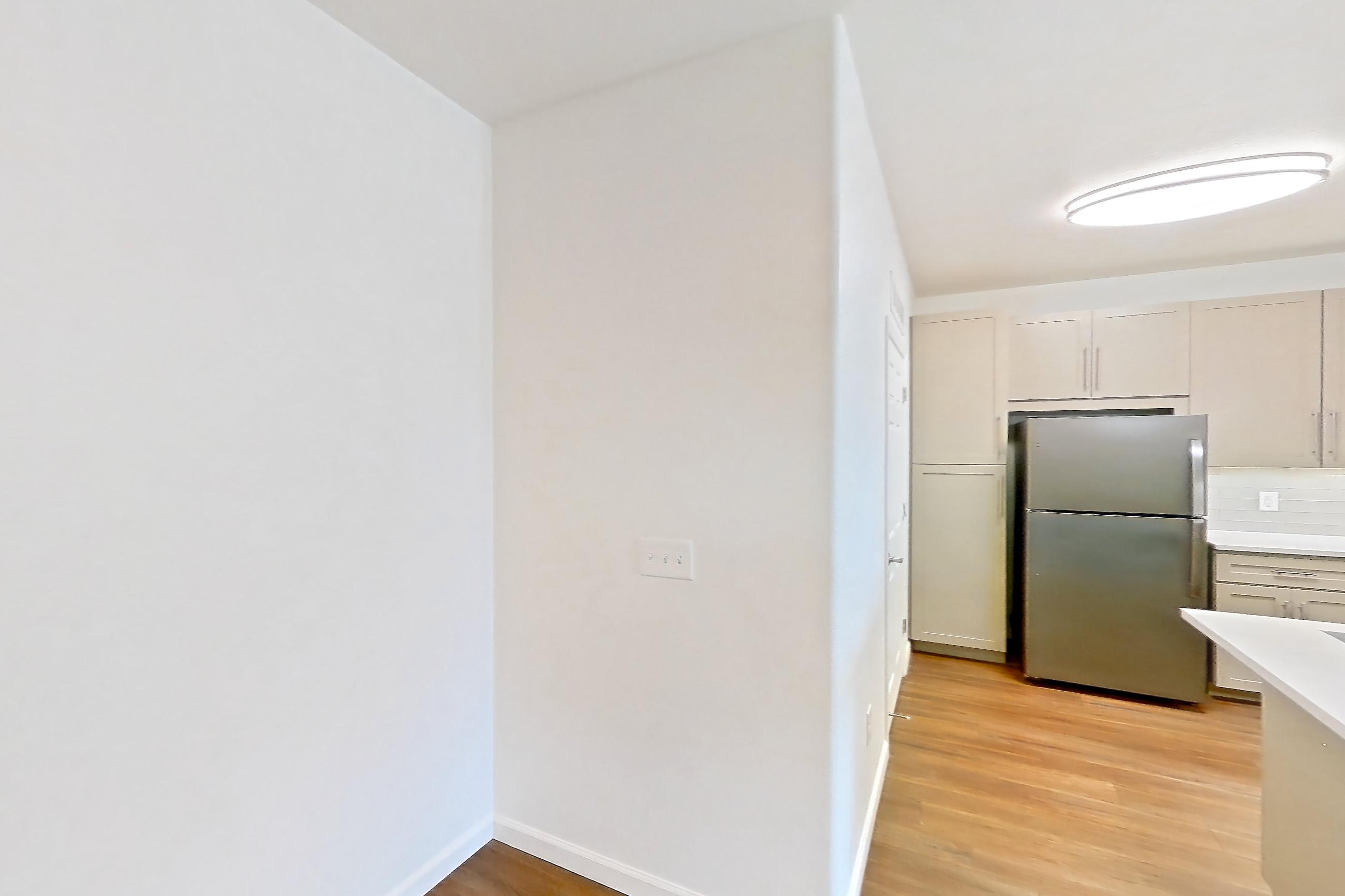 Dining room with dark wood-finish flooring, electric range, light countertops, light wood-finish flooring, oven/range, refrigerator, and stainless steel appliances, Apartment 1066 at Cortland South Mountain