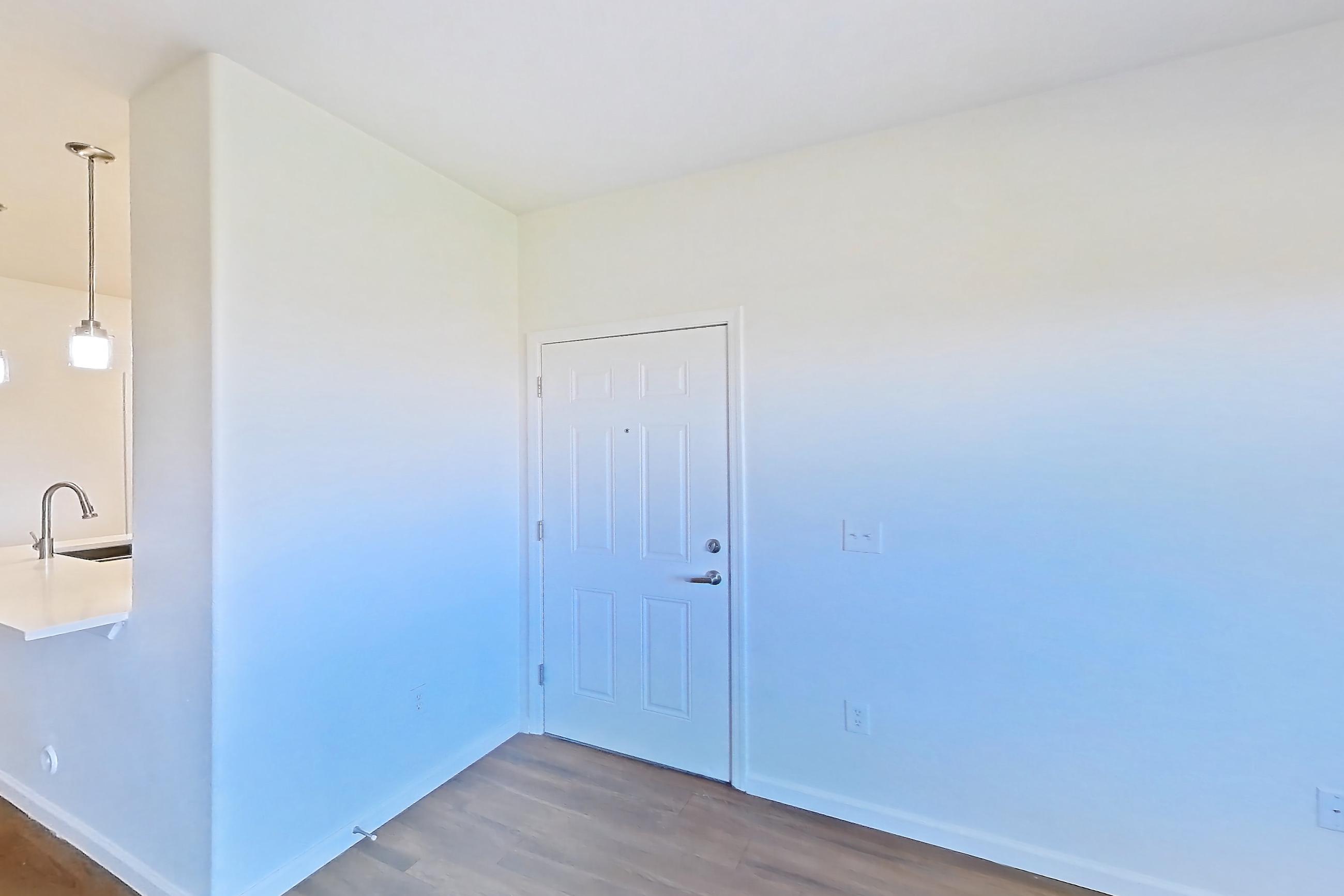 Living room with dark wood-finish flooring, Apartment 1066 at Cortland South Mountain