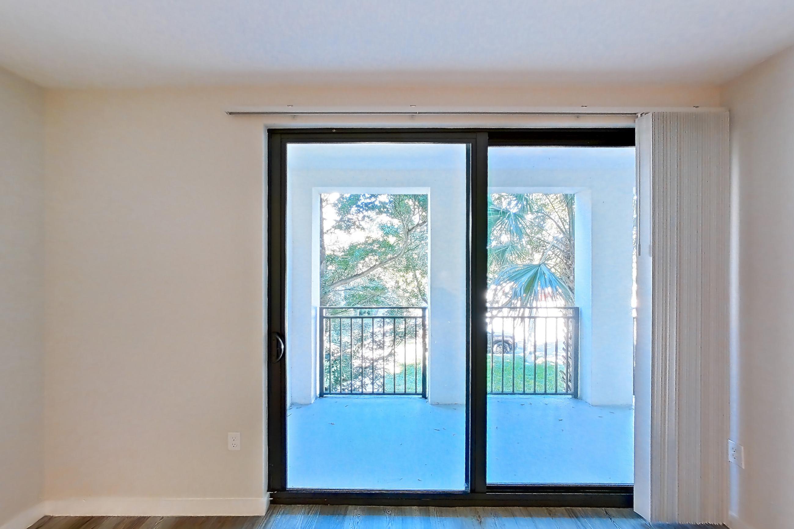 Living room with dark wood-finish flooring, Apartment 04-206 at Cortland South Kendall