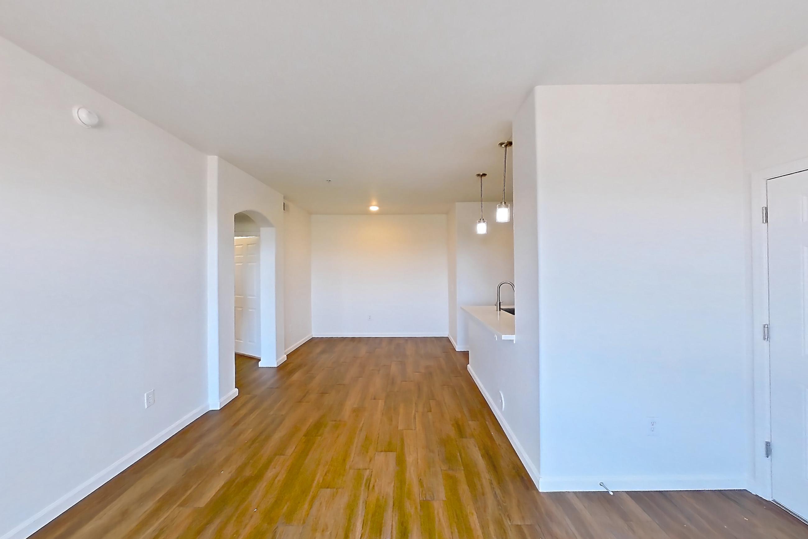 Living room with dark wood-finish flooring, Apartment 3091 at Cortland South Mountain