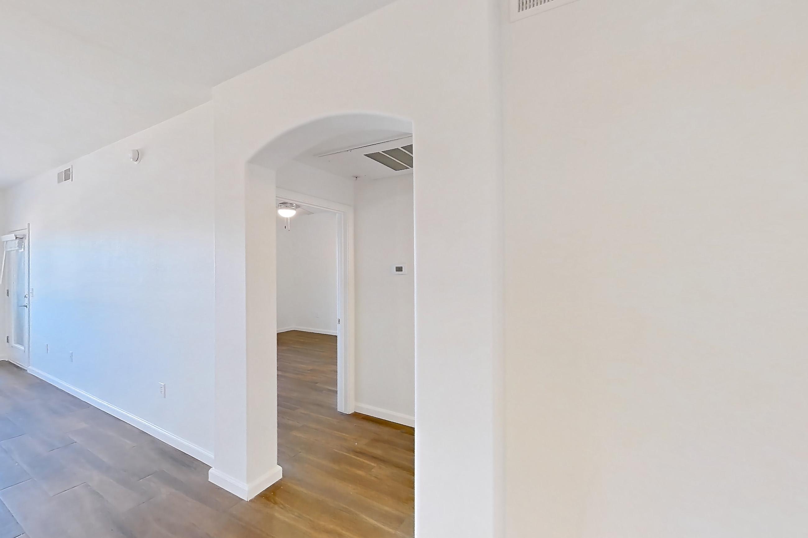 Dining room with black appliances, dark wood-finish flooring, light countertops, oven/range, refrigerator, and stainless steel appliances, Apartment 3101 at Cortland South Mountain