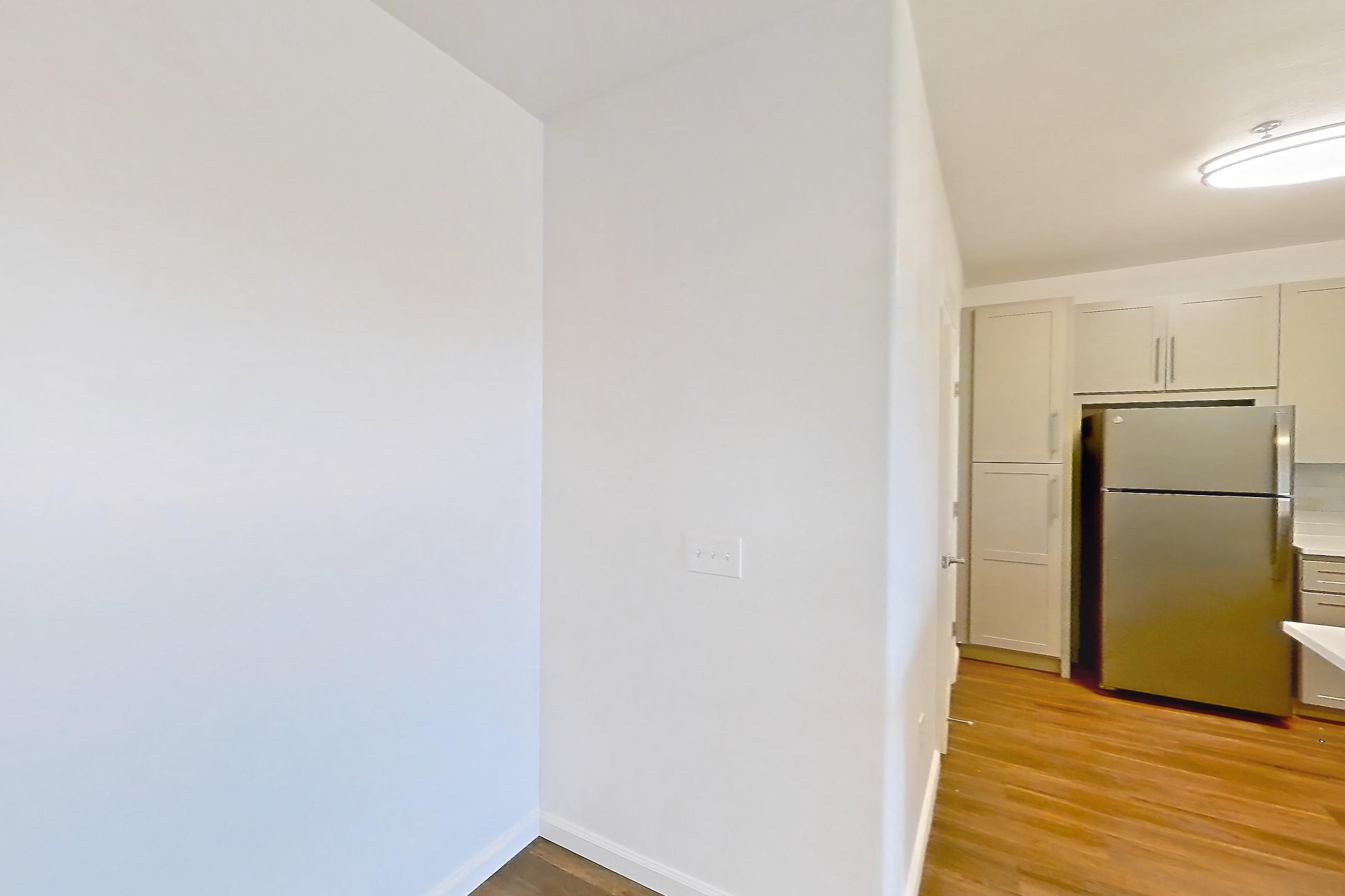 Dining room with black appliances, dark wood-finish flooring, light countertops, oven/range, refrigerator, and stainless steel appliances, Apartment 3101 at Cortland South Mountain