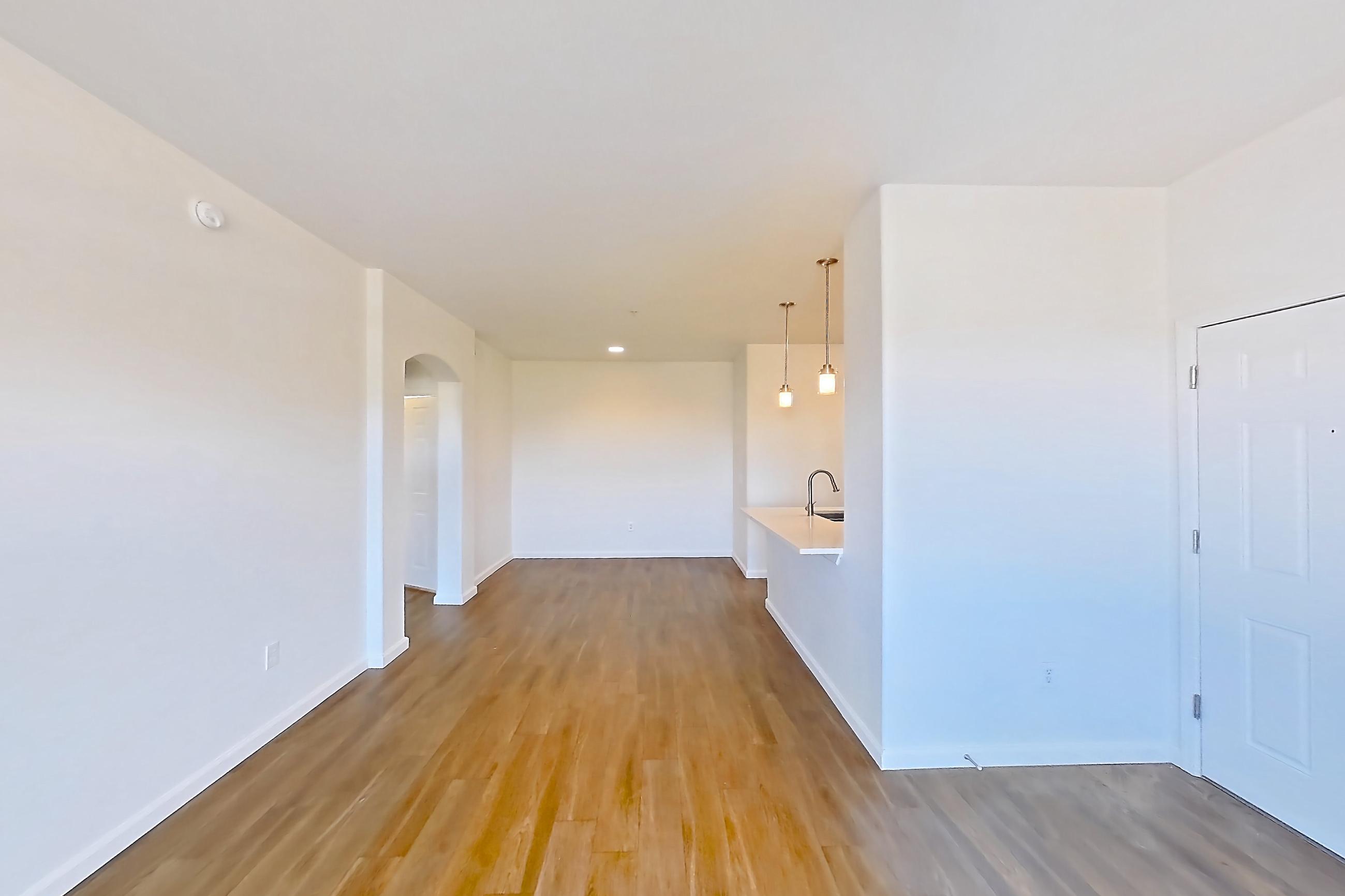 Living room with dark wood-finish flooring, Apartment 3101 at Cortland South Mountain
